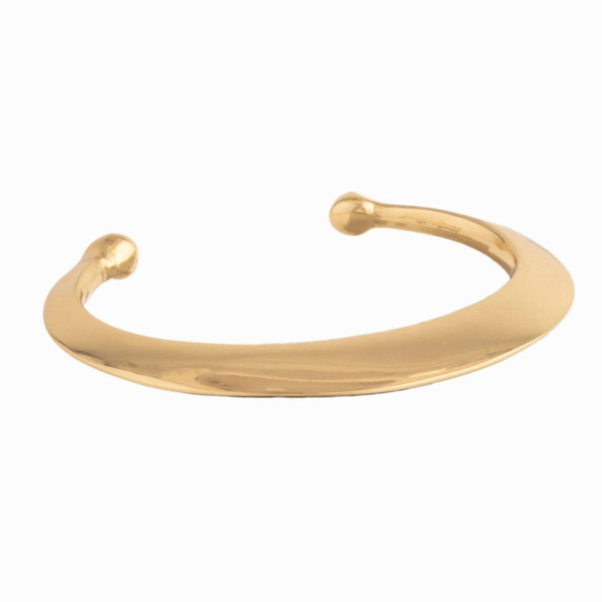 Wide tapered gold cuff bracelet with rounded ball ends shown at an angle on a white background