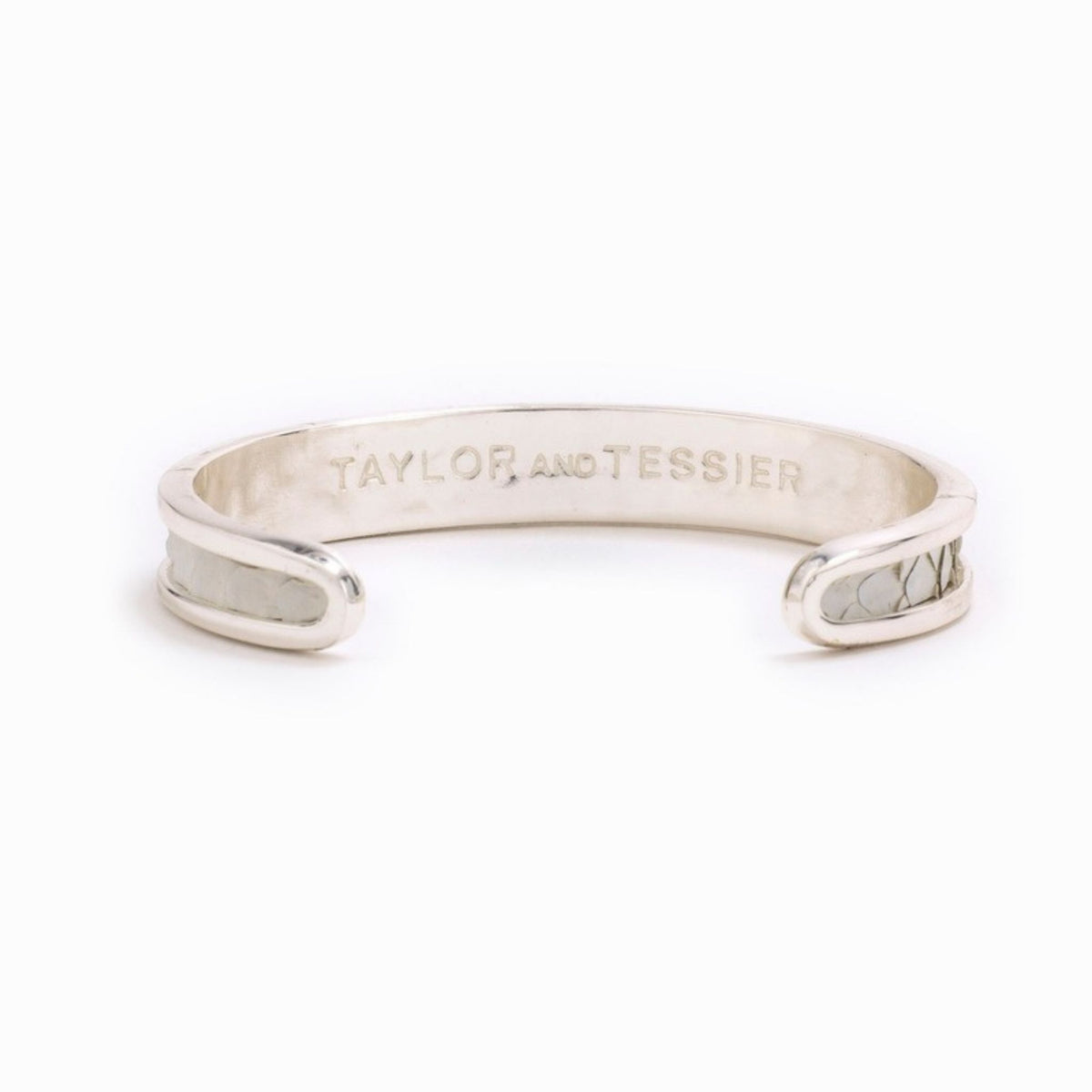 Small Taylor & Tessier cuff bracelet, .5in wide, inside view, white python-embossed leather on a silver band