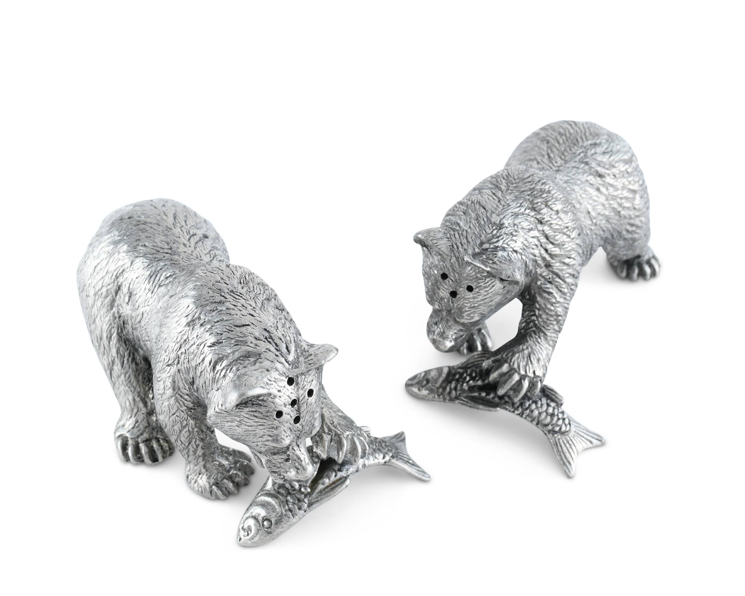 Two silver bear figurines with fish on a white background