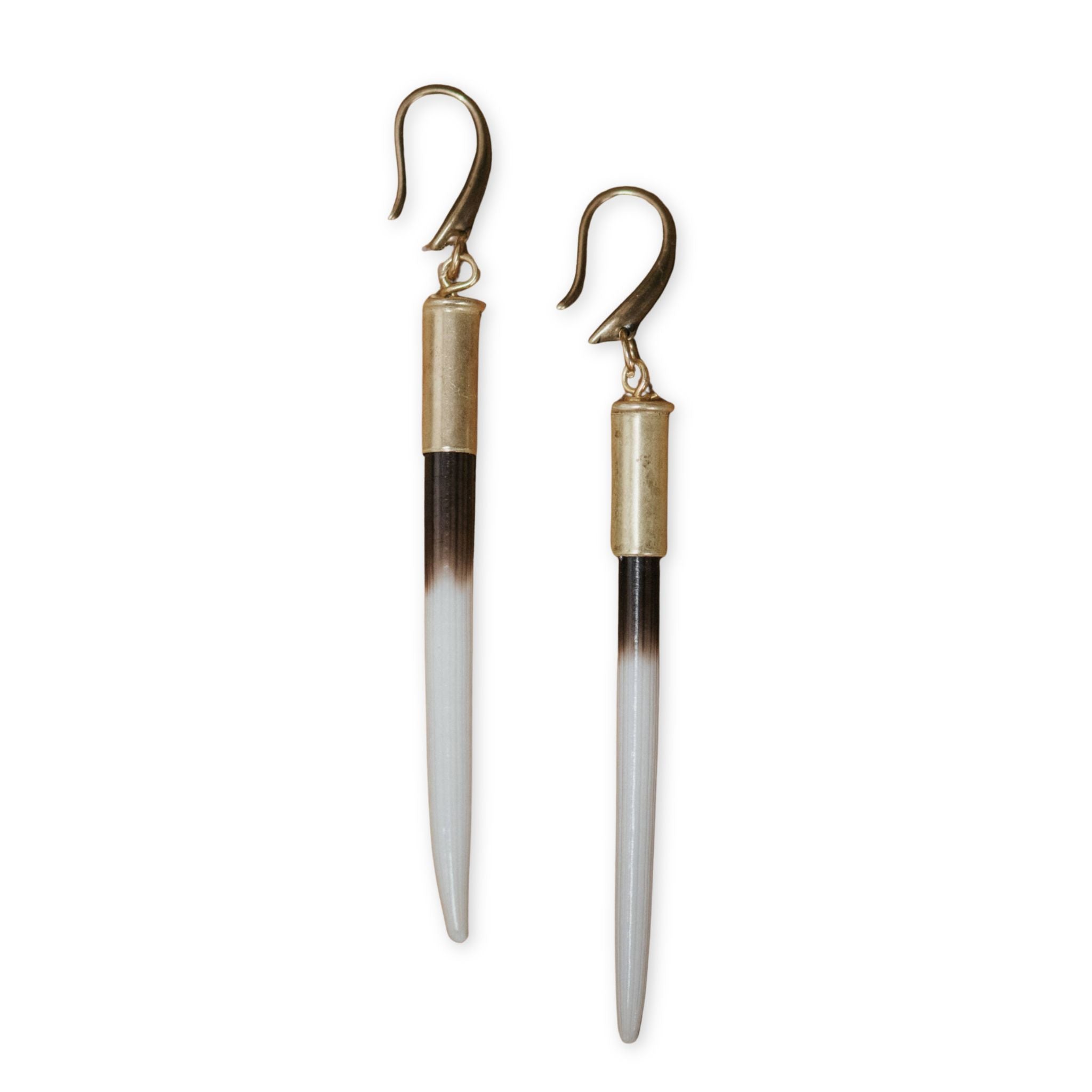 Tapered earrings with gold and silver finishes on a white background