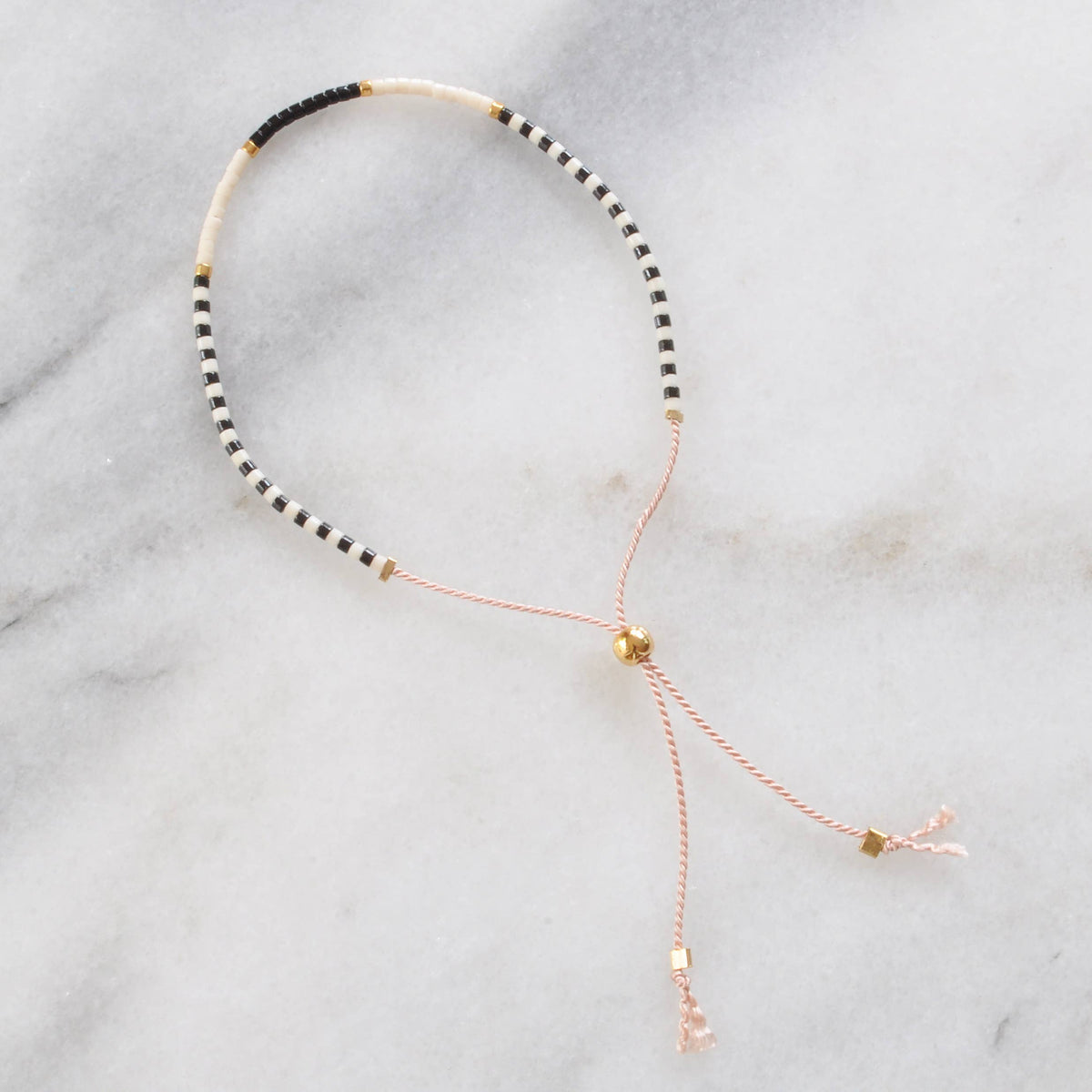 Beaded Bracelet with black, white, and gold beads.