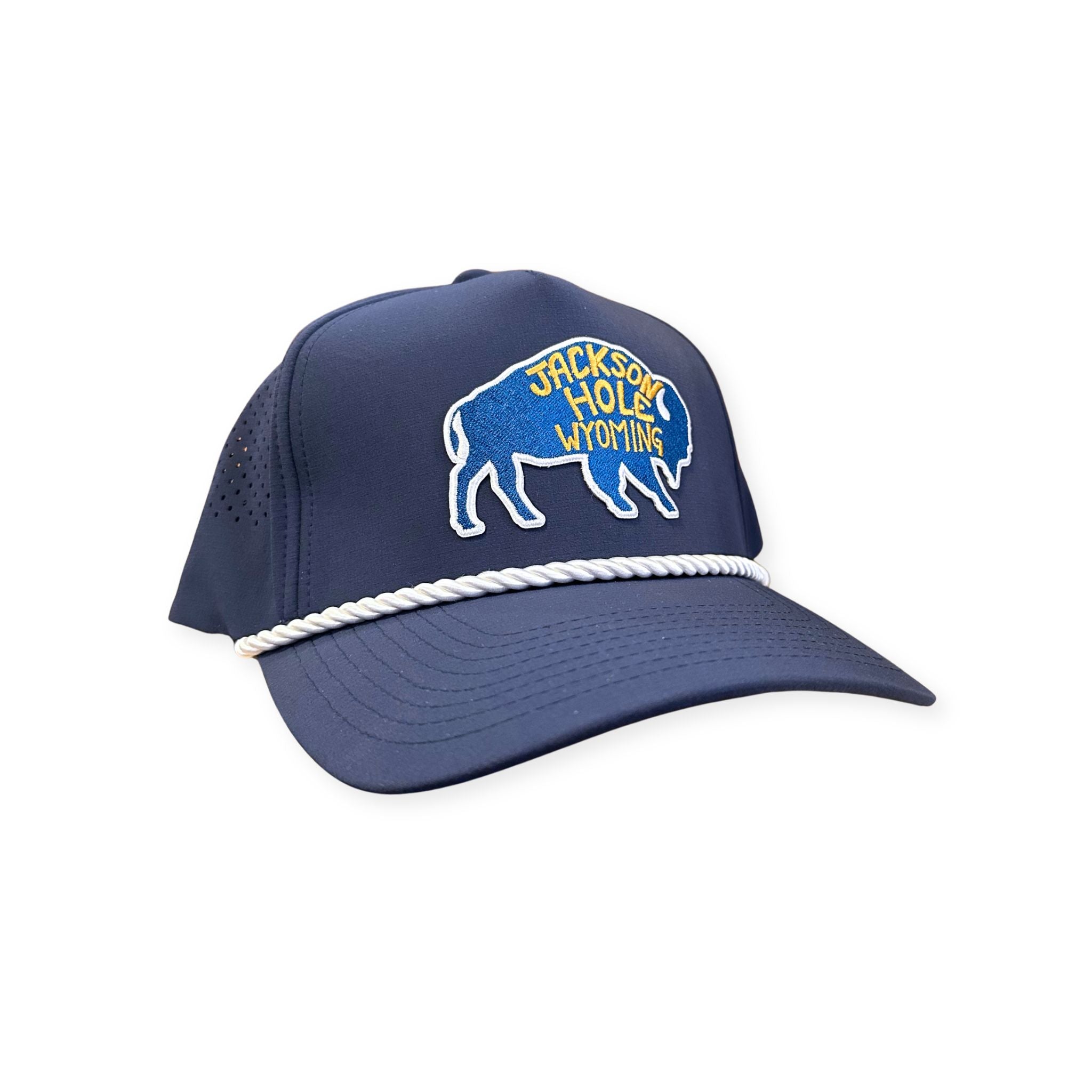 A navy rope trucker hat. Features a blue bison patch, with yellow lettering that reads "JACKSON HOLE WYOMING"
