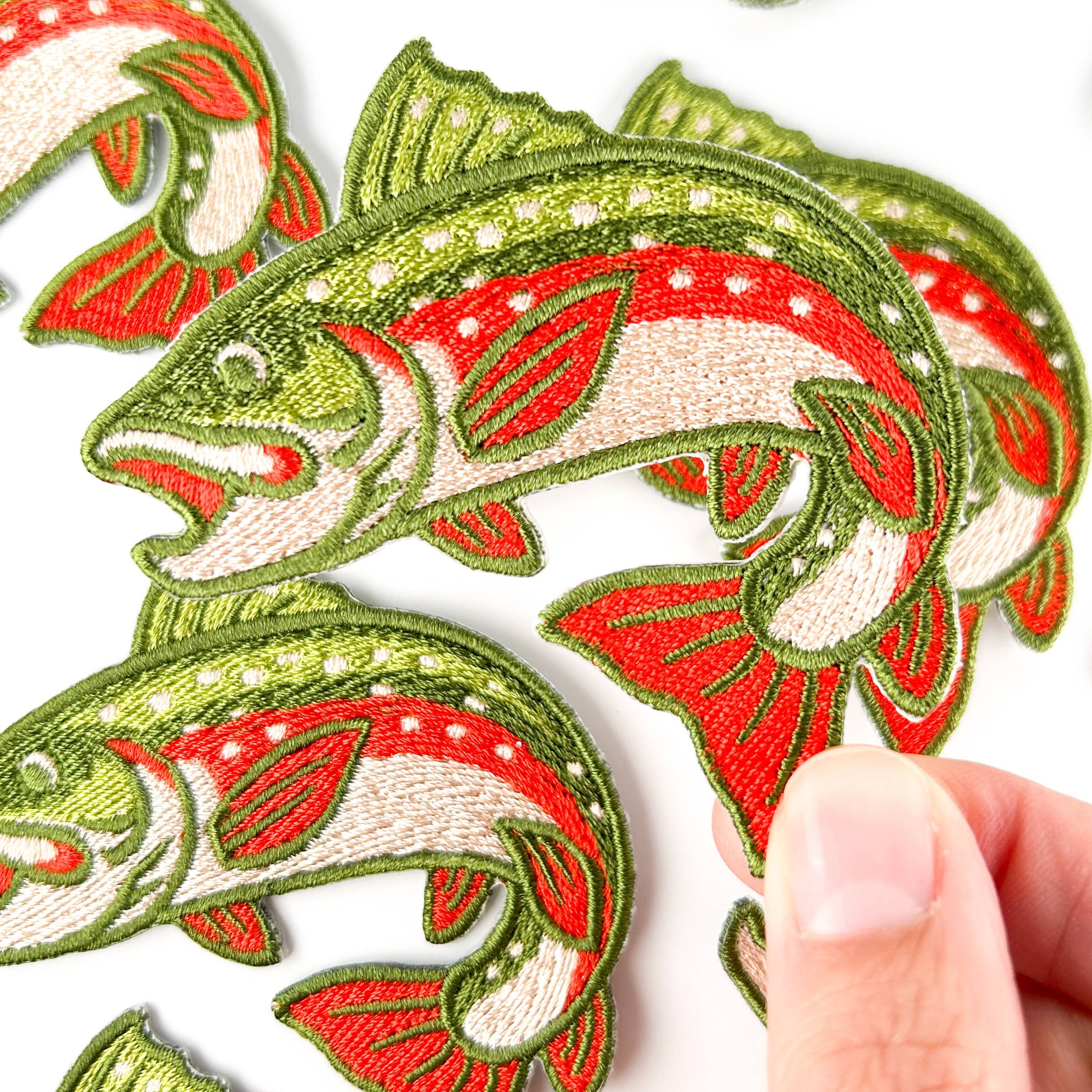 Embroidered iron on patch of a brook trout with red and green design.