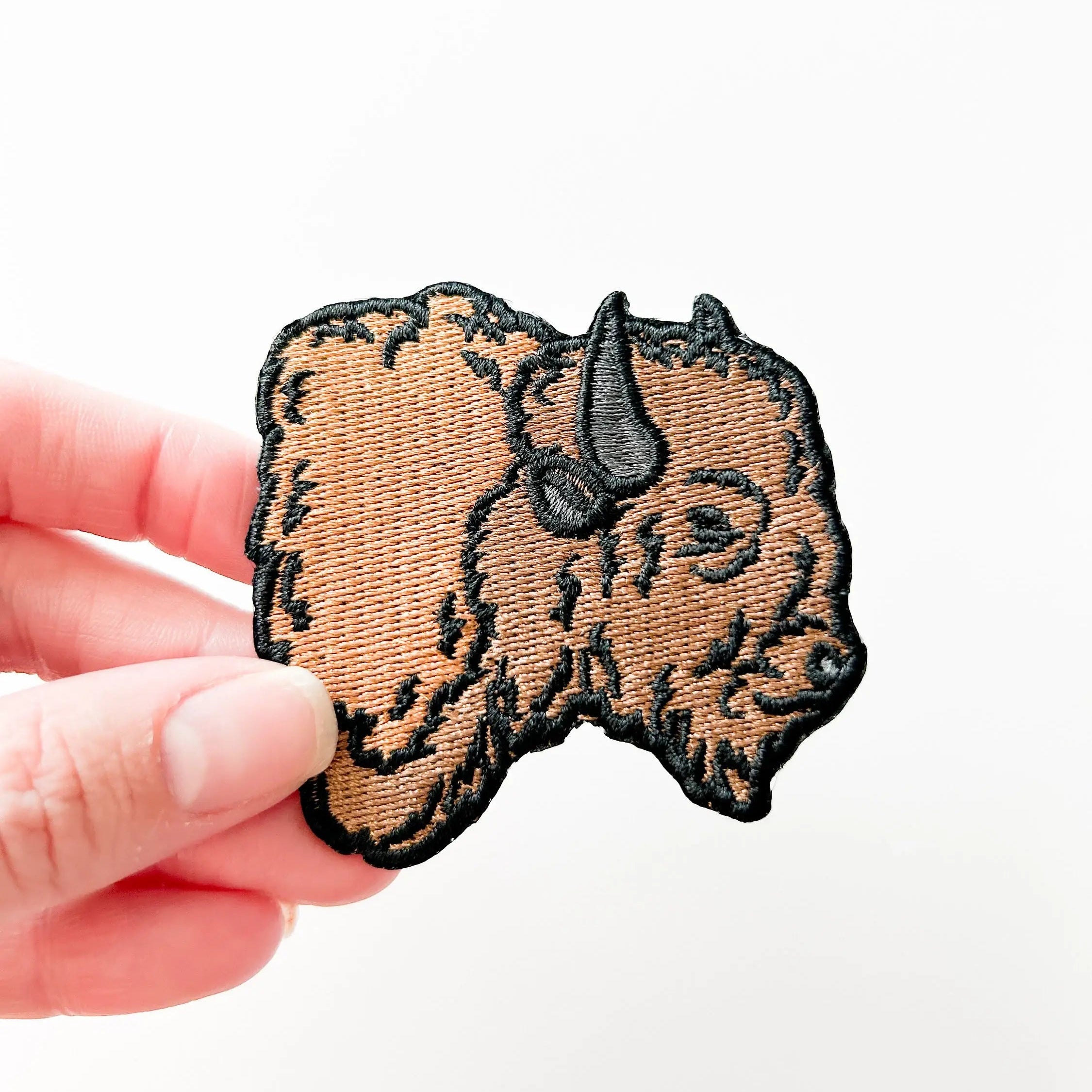Embroidered iron on patch of a buffalo head.