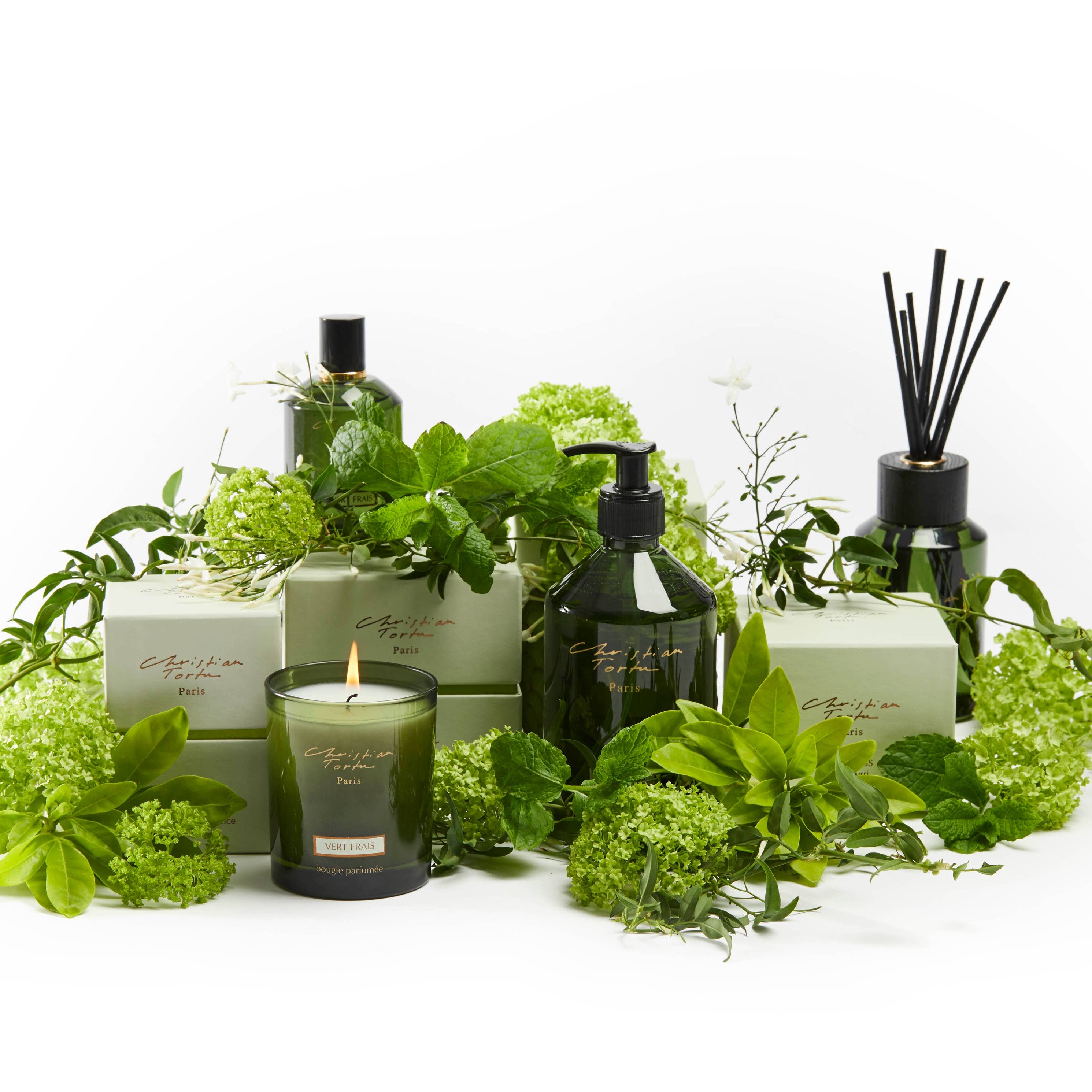 Green-themed home fragrance products including candles, diffusers, and bottles on a white background.