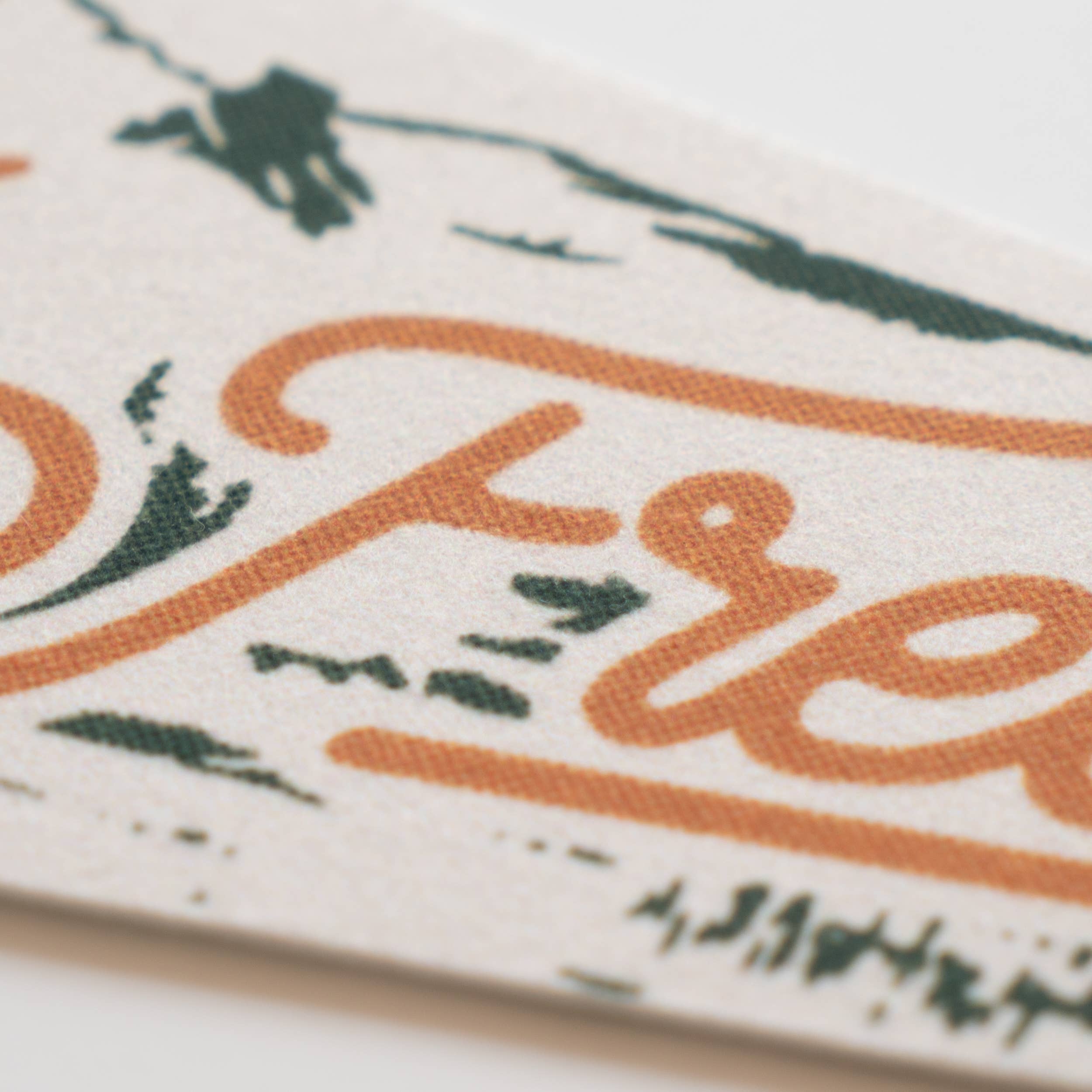 Close-up of a decorative item with 'Love' text and floral patterns.