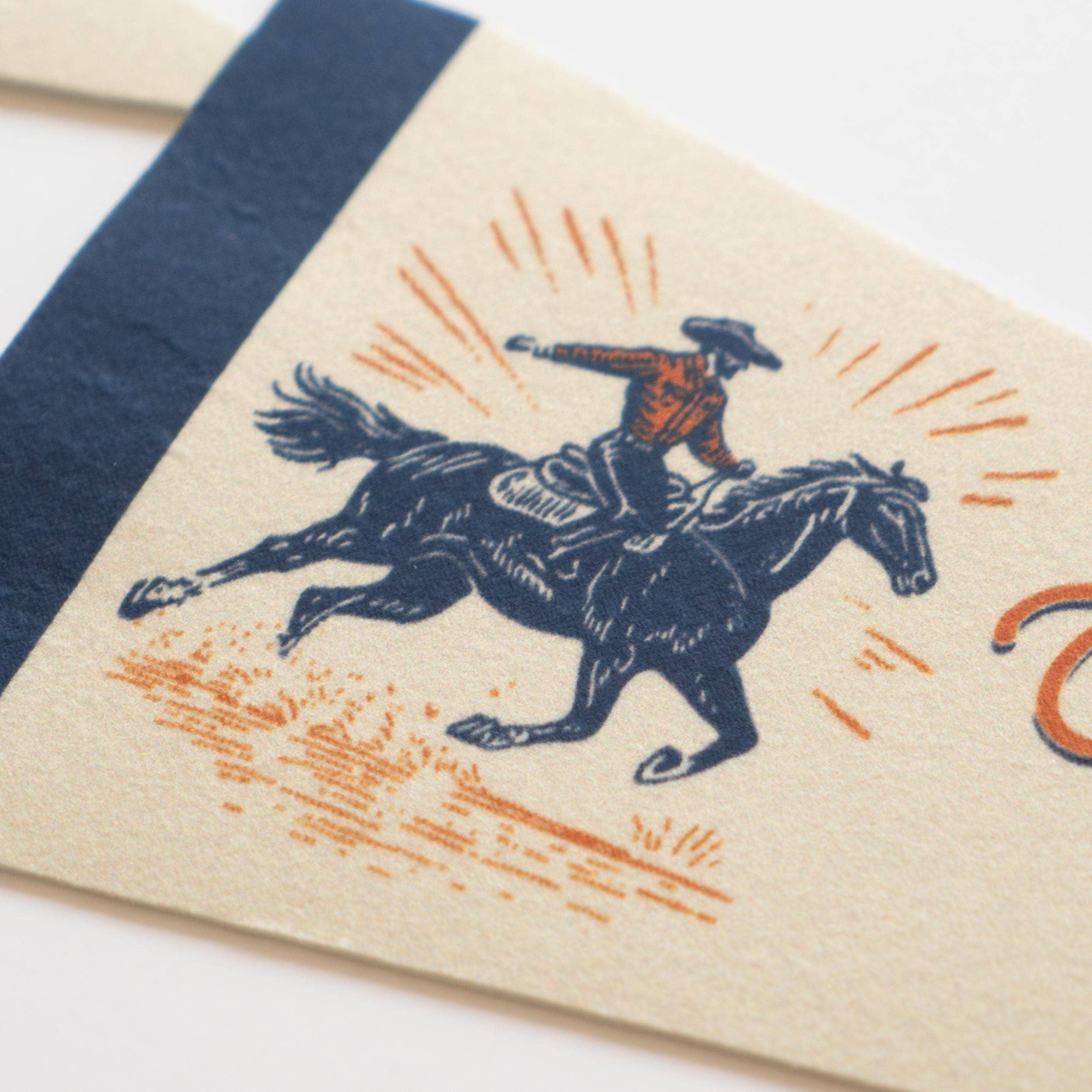 Notebook with a cowboy riding a horse illustration on a beige cover.
