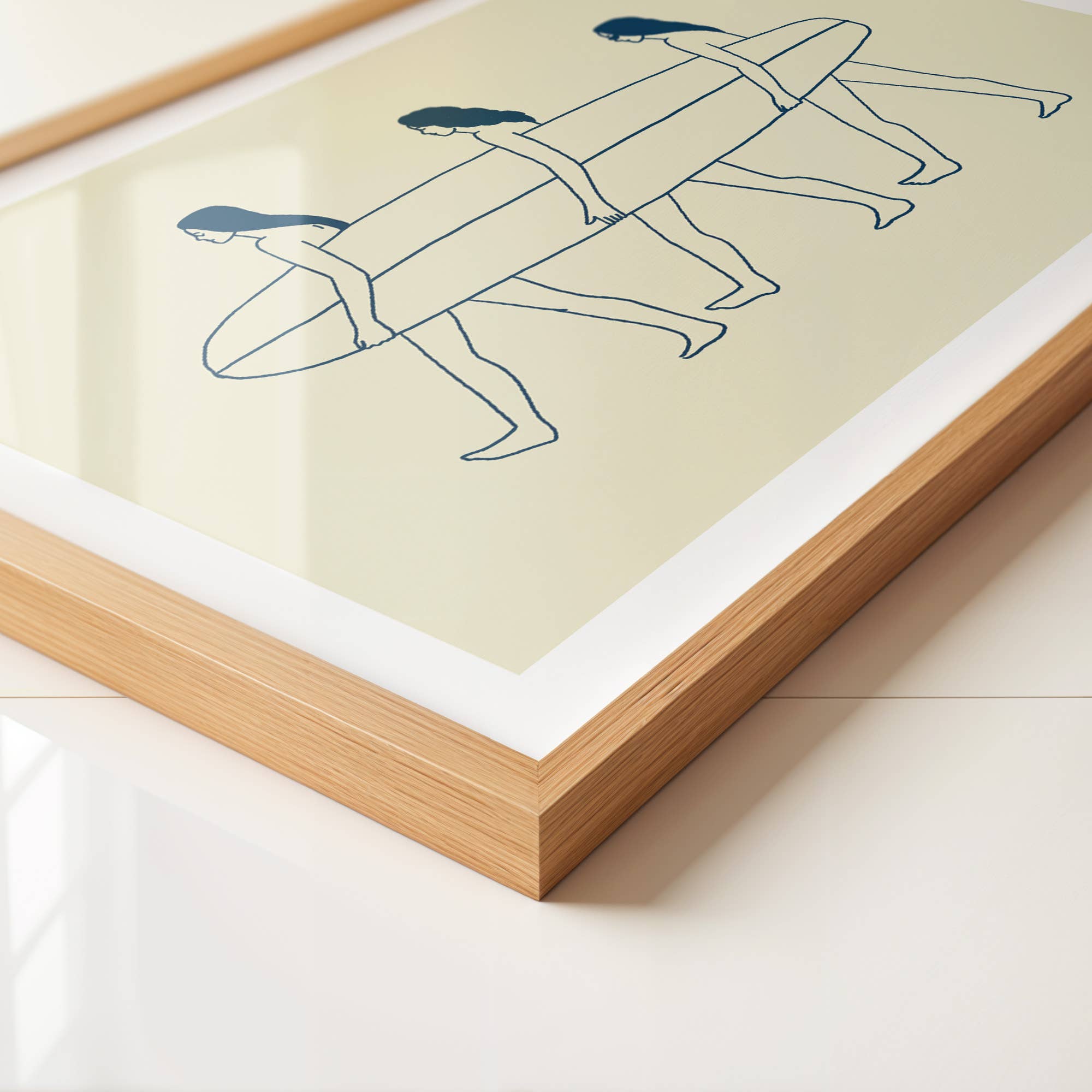 Framed artwork with line drawing of two people on a surfboard on a light green background
