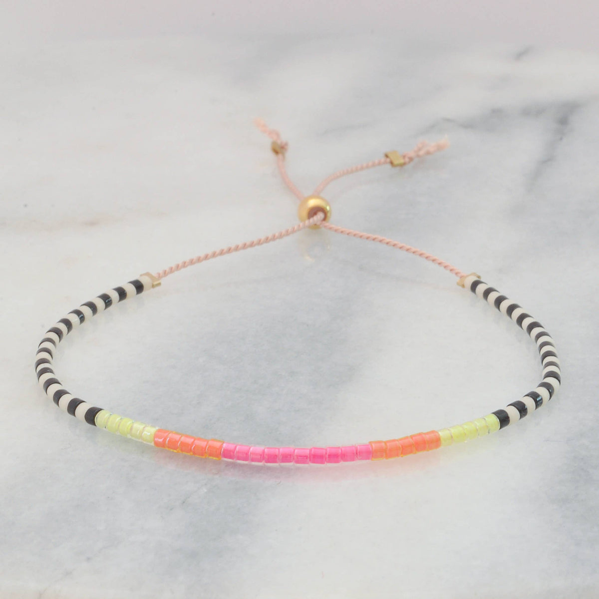 Neon beaded bracelet with black and white pattern.
