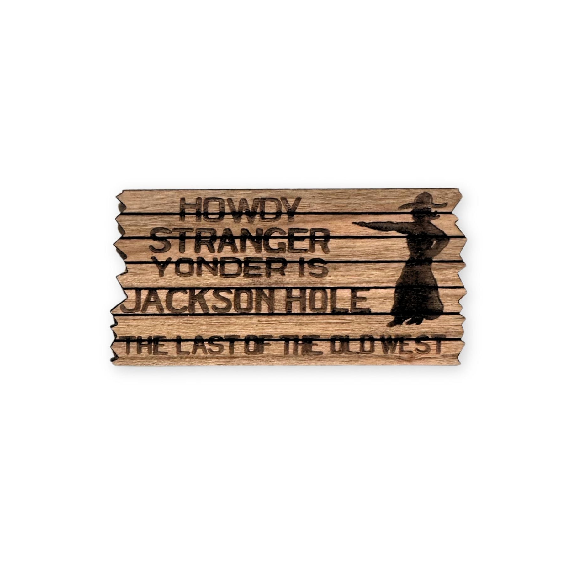 Wooden sign with text 'Howdy Stranger, Yonder is Jackson Hole, The Last of the Old West' on a white background