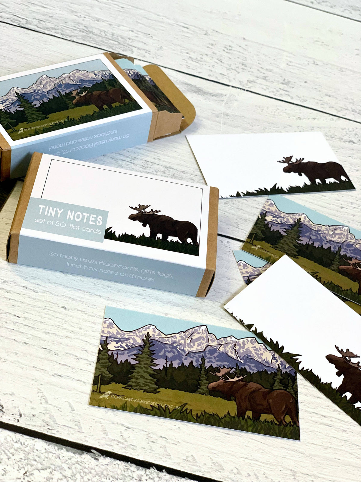 A set of illustrated cardstock notes and matching card sleeves featuring a moose and mountain landscape.