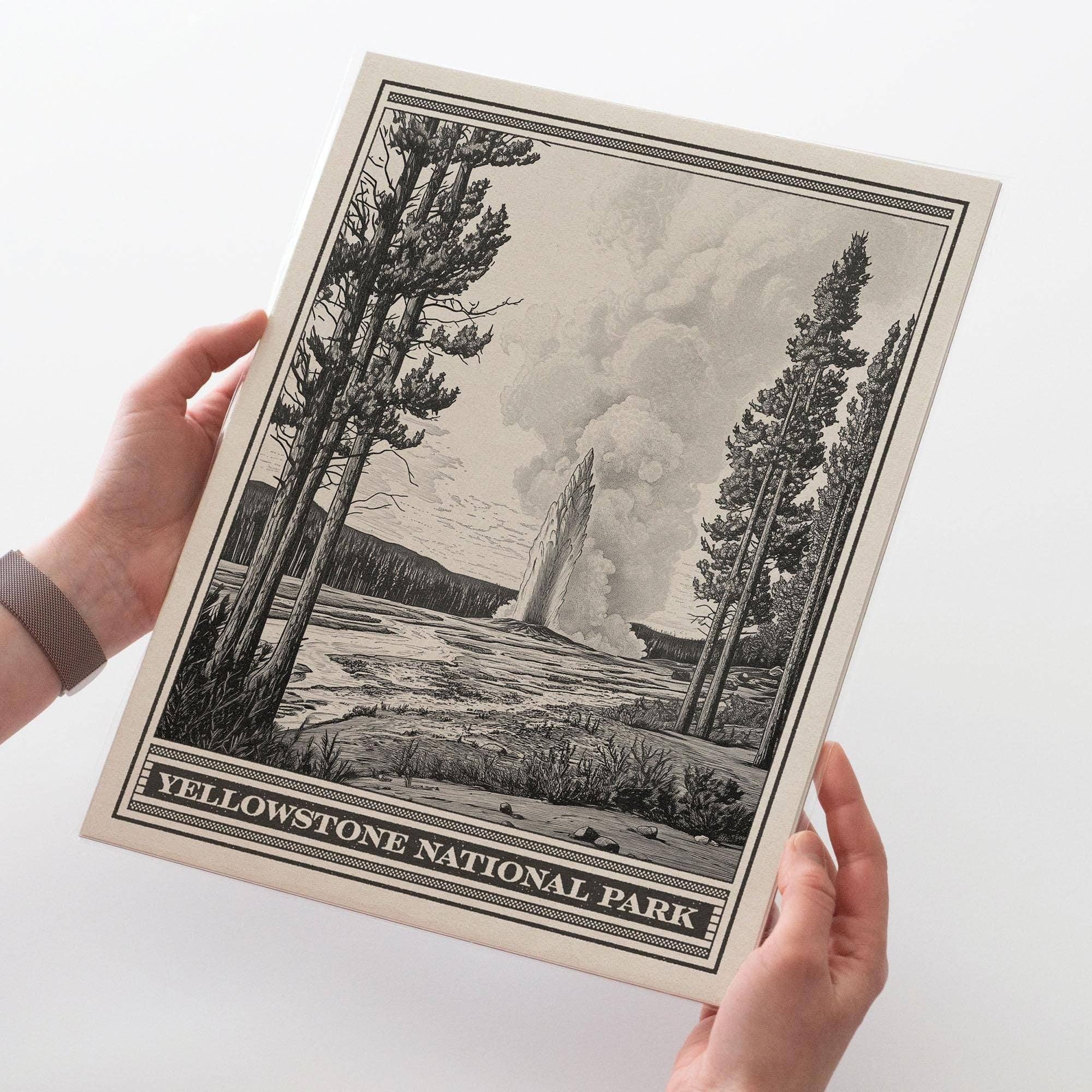 Print of Yellowstone National Park with a person holding it on a white background