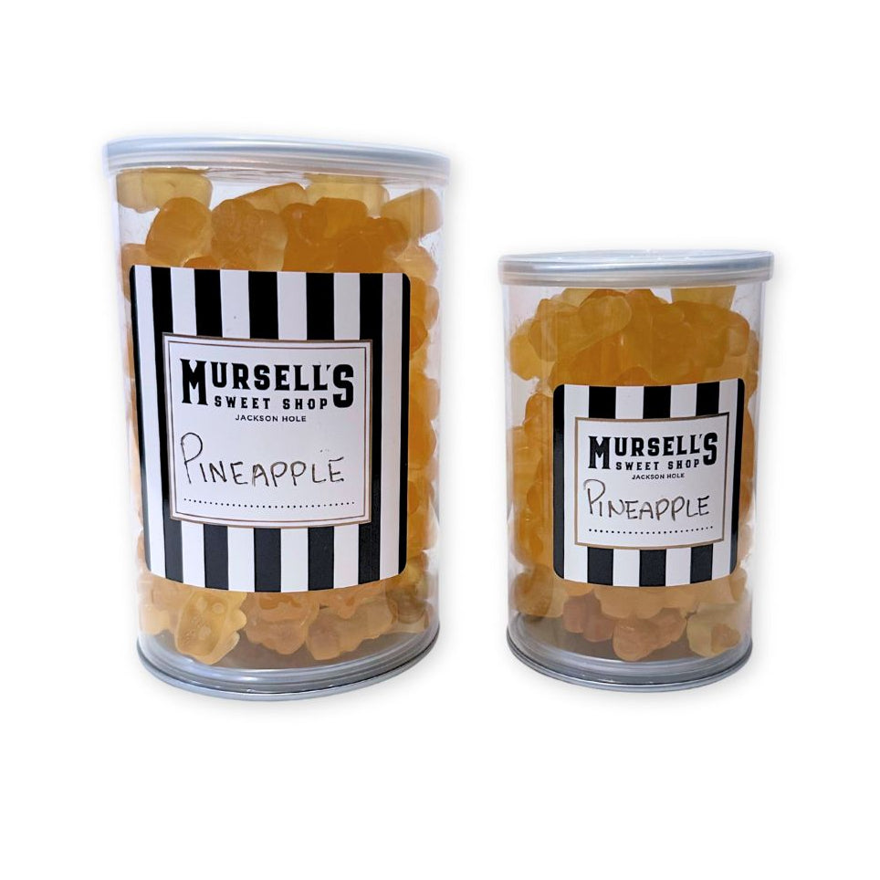 Two cans of Mursell's Sweet Shop pineapple gummi bears on a white background