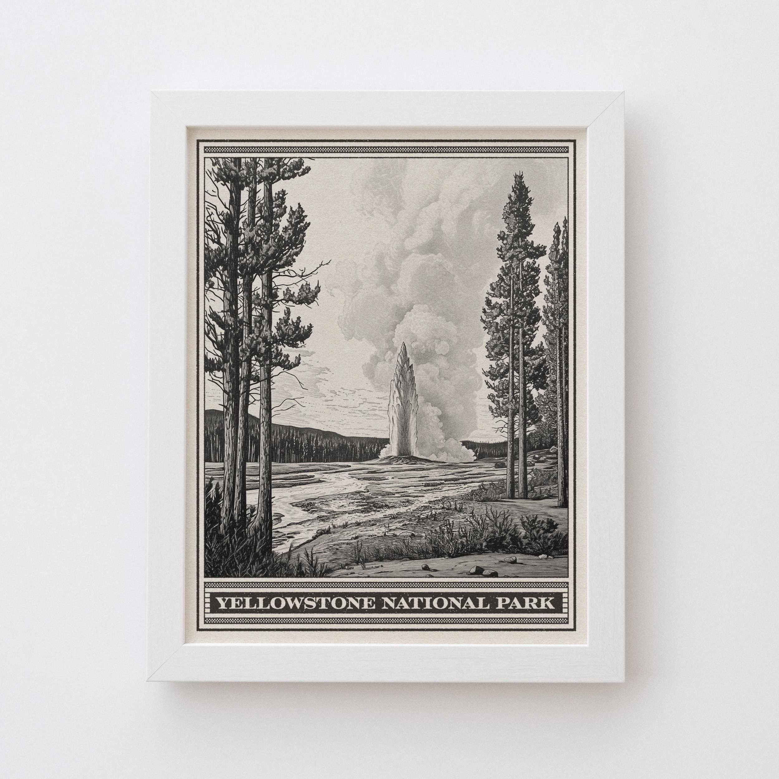 Framed black and white print of Yellowstone National Park with trees and a geyser.