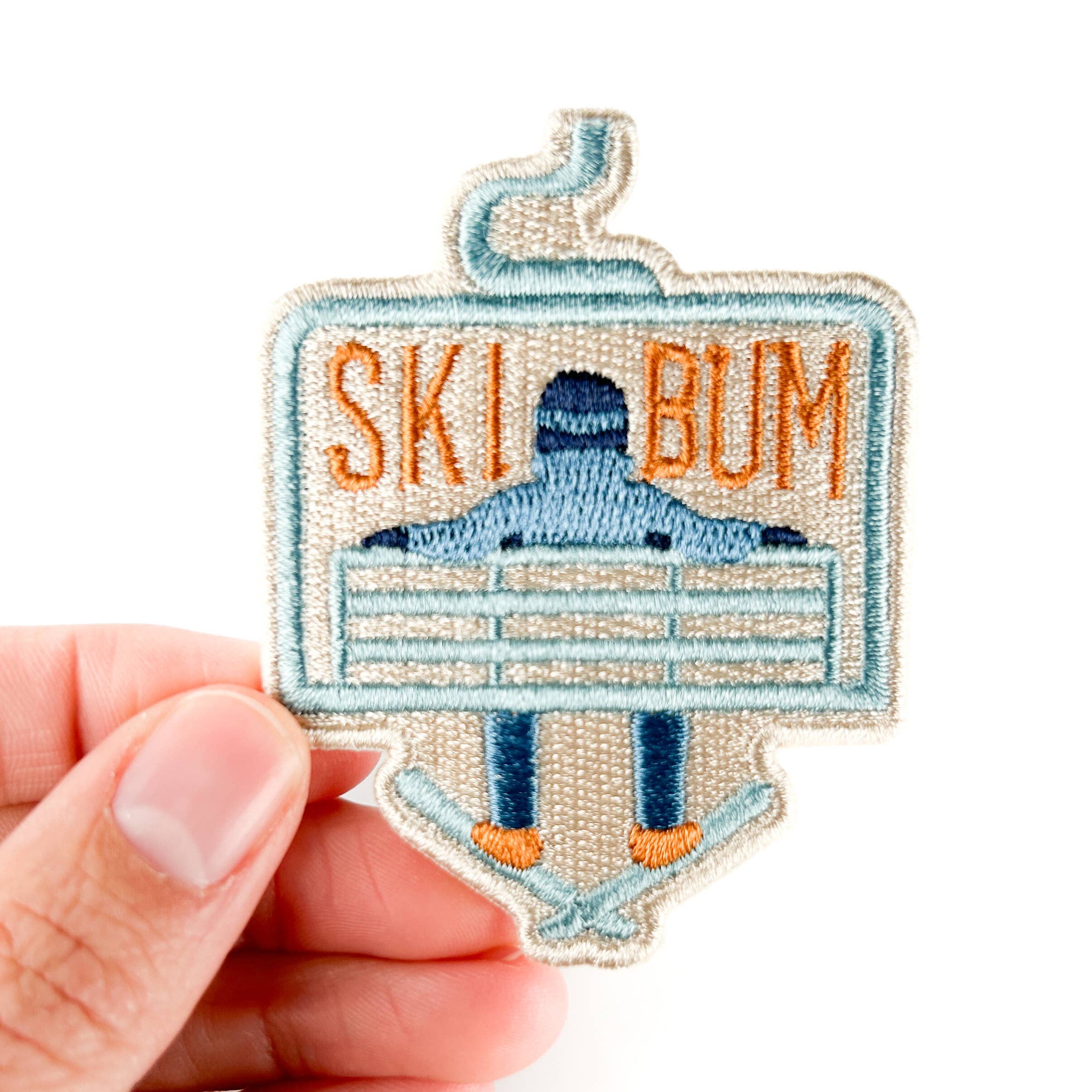 Embroidered iron on patch with 'Ski Bum' text and a skier design.