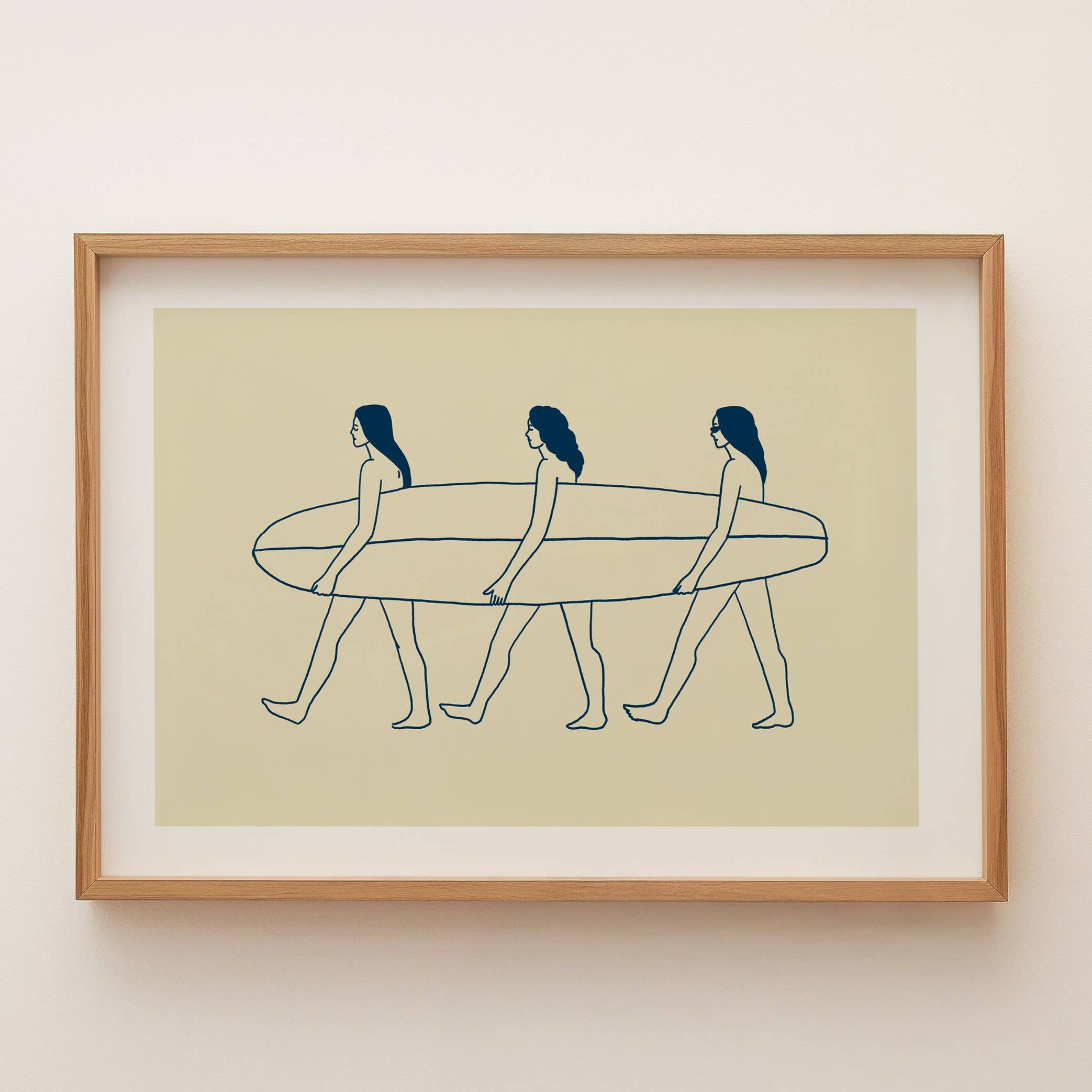 Framed artwork of three women walking with a surfboard on a beige background