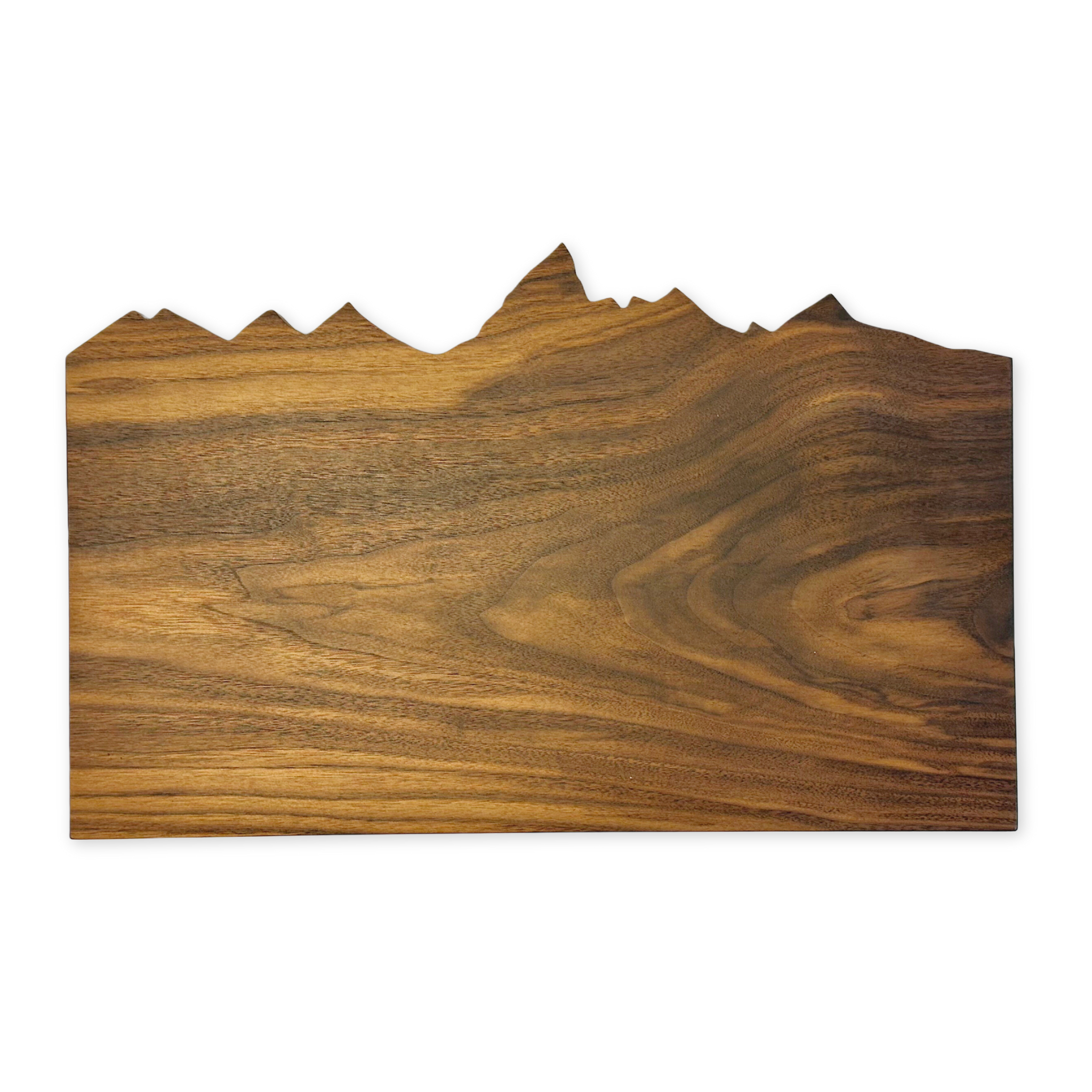 handcrafted cutting board with the top edge cut out in the shape of the teton range
