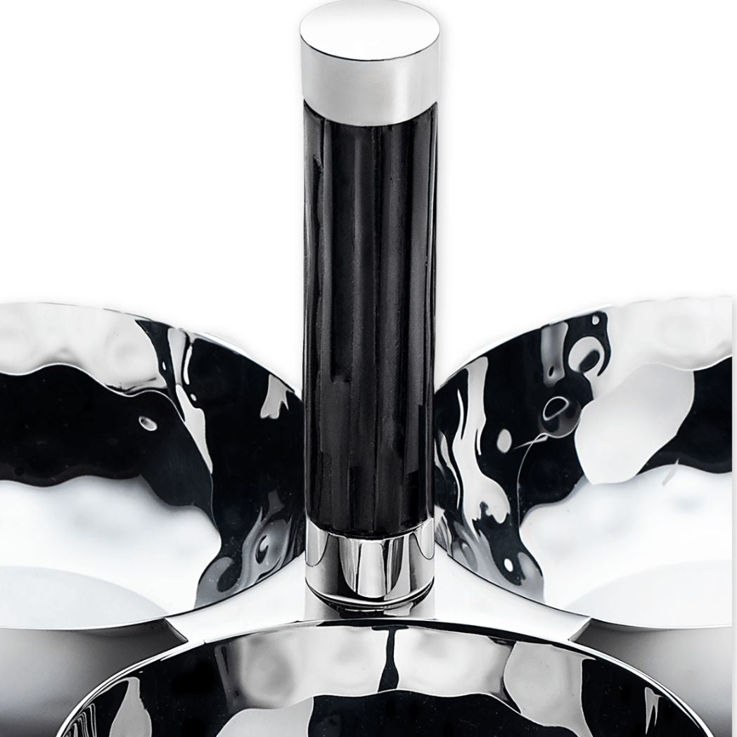 Metallic object with a cylindrical design on a reflective surface