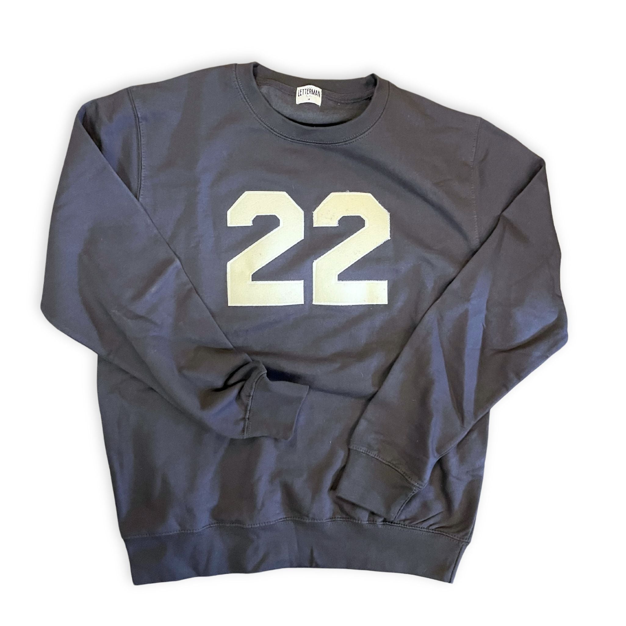A gray sweatshirt with the number 22 printed in a contrasting color on the front.