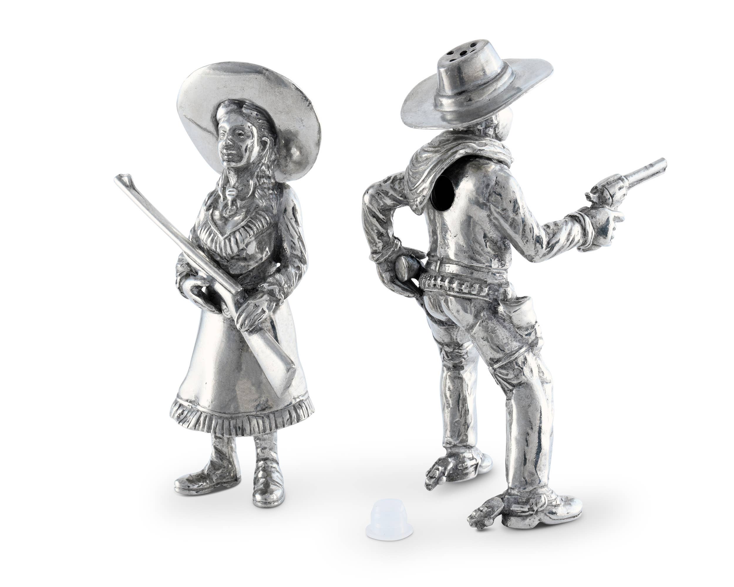 Two silver cowboy and cowgirl figurines on a white background