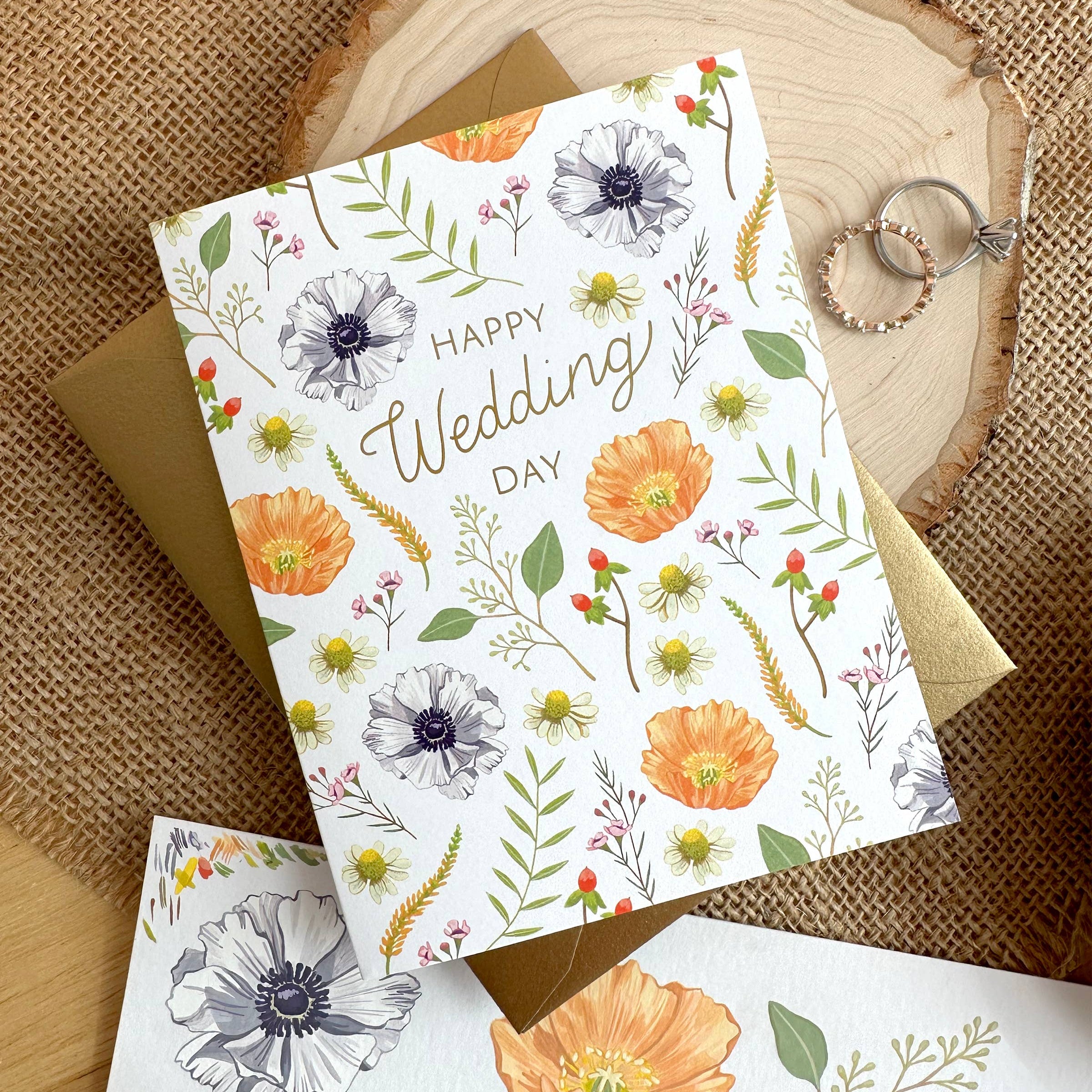 Floral wedding card with 'Happy Wedding Day' text on a wooden surface