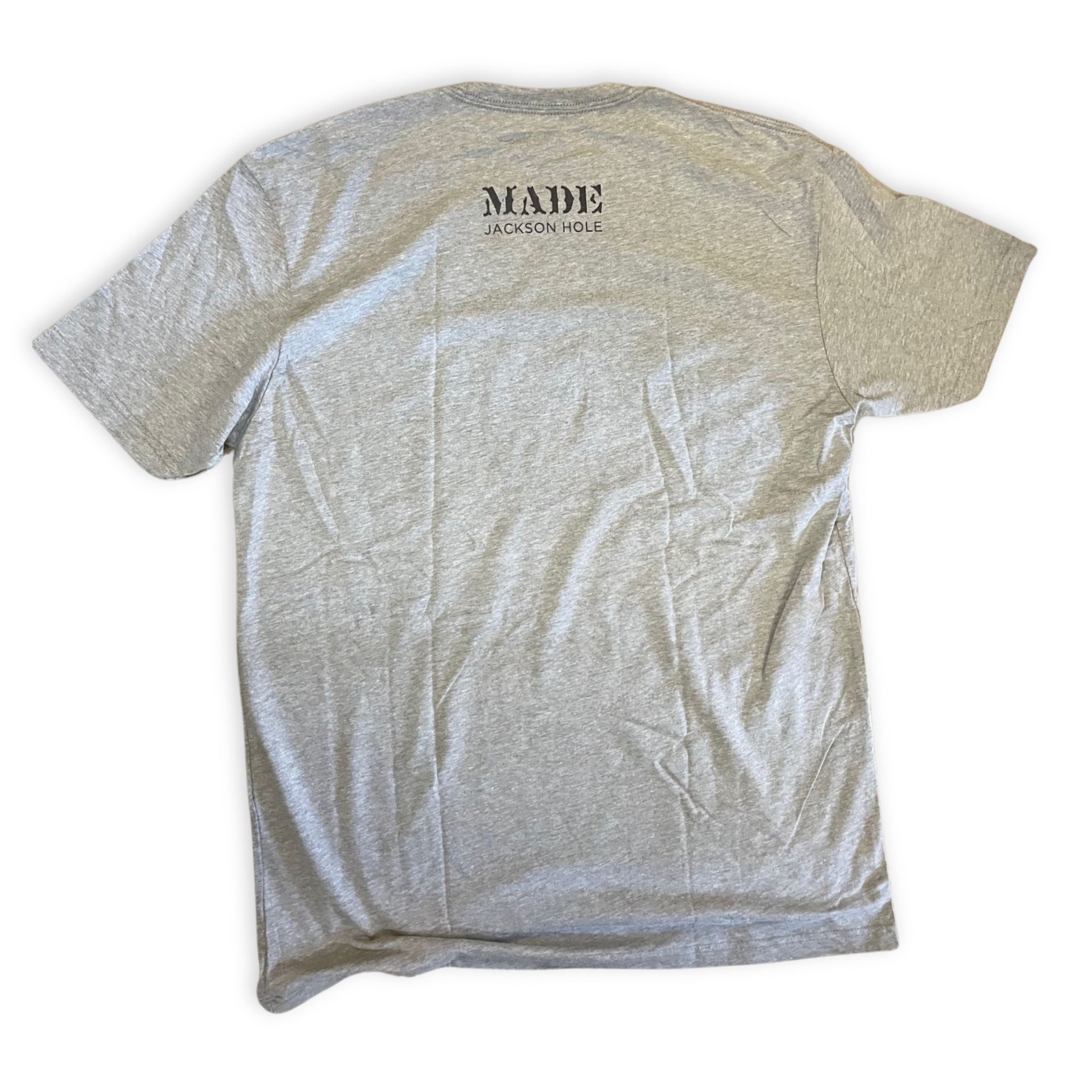 back of grey tshirt with a small store logo on the nape of the neck
