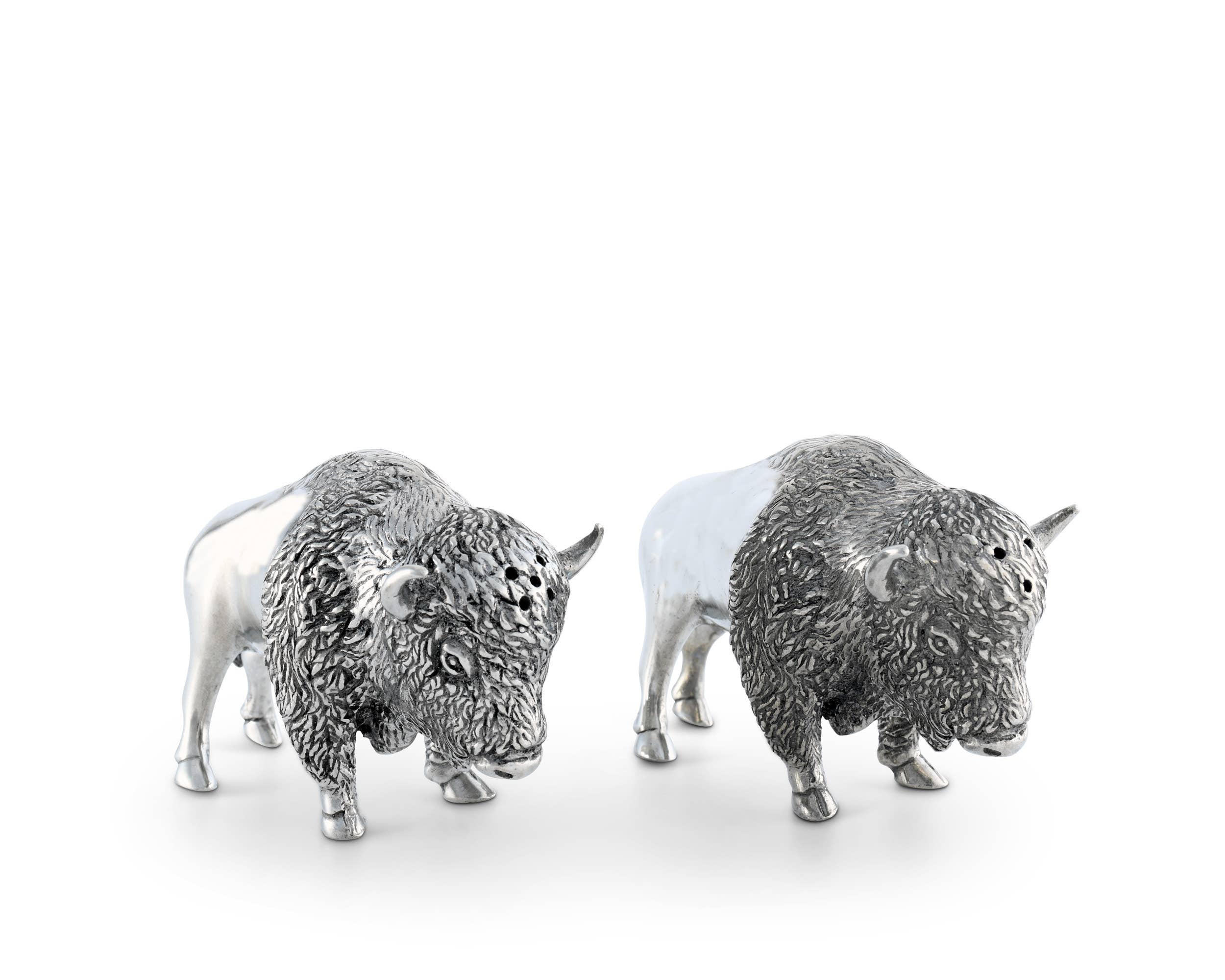 Two silver buffalo figurines on a white background