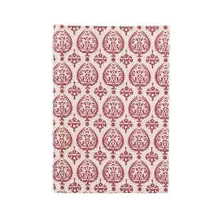 A hardbound journal with a red hand block print design on the cover.