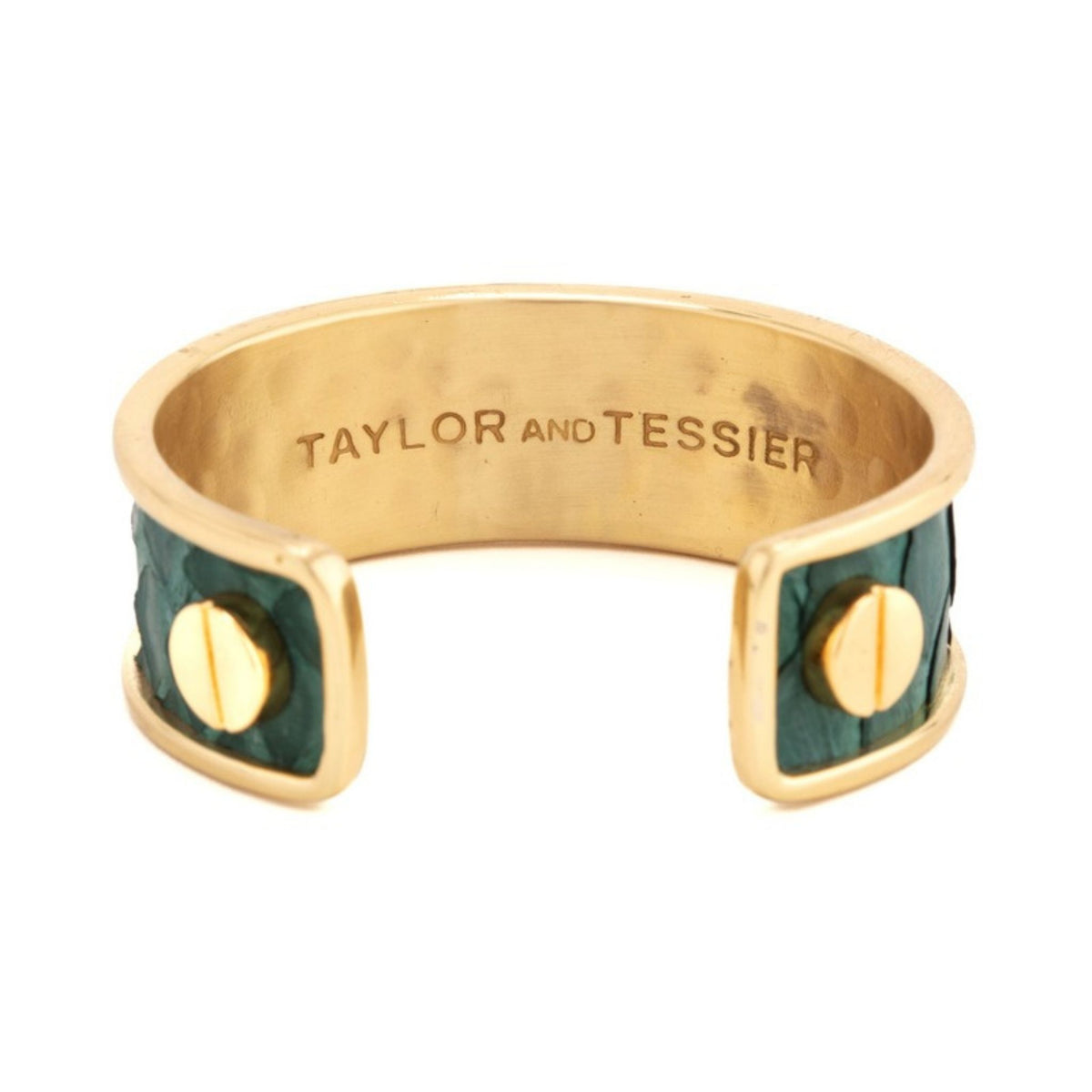 Inside view of a gold cuff with deep green leather panels, gold screw heads and the engraved brand name