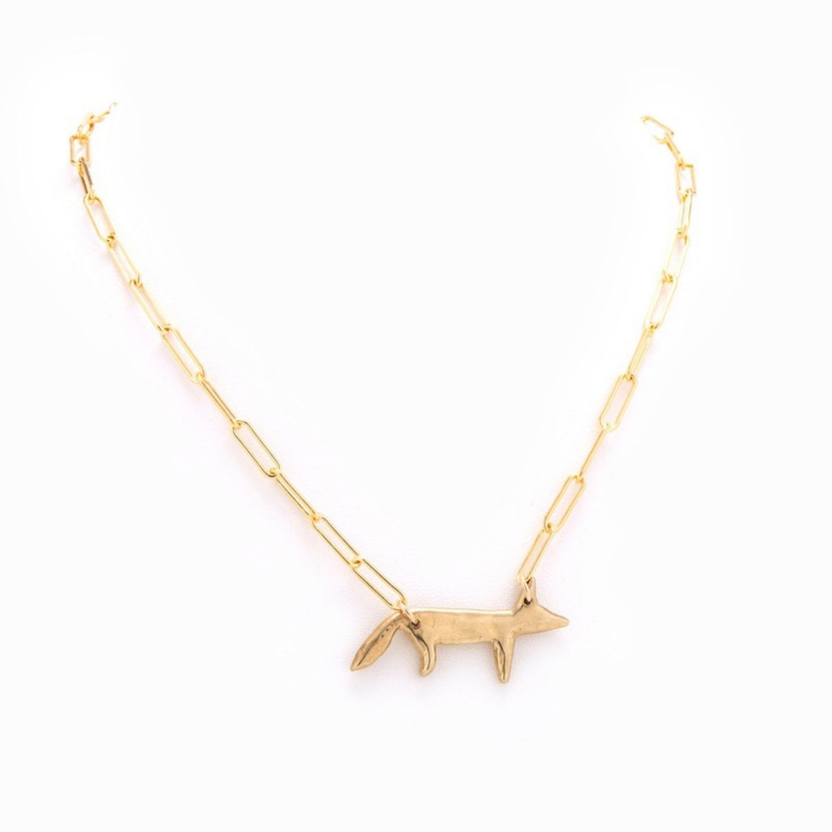 The Foxy Gold Necklace by Taylor & Tessier, a gold-filled paperclip chain with a small hammered brass fox pendant