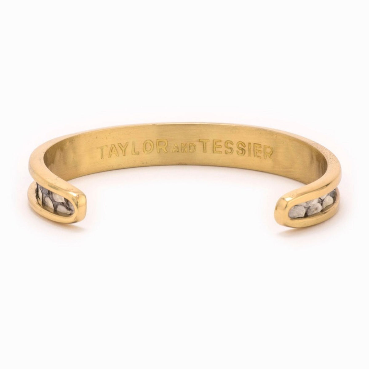 Small Taylor & Tessier cuff bracelet, .5in wide, inside view, black and white python-embossed leather on a gold band