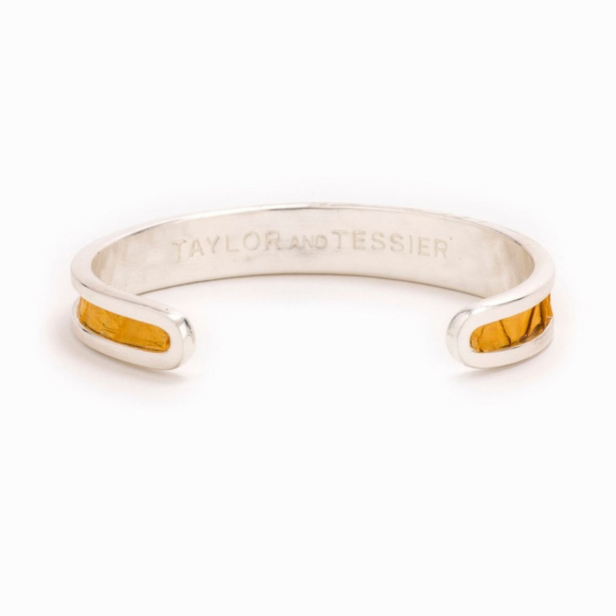 Small Taylor & Tessier cuff bracelet, .5in wide, inside view, mustard yellow python-embossed leather on a silver band