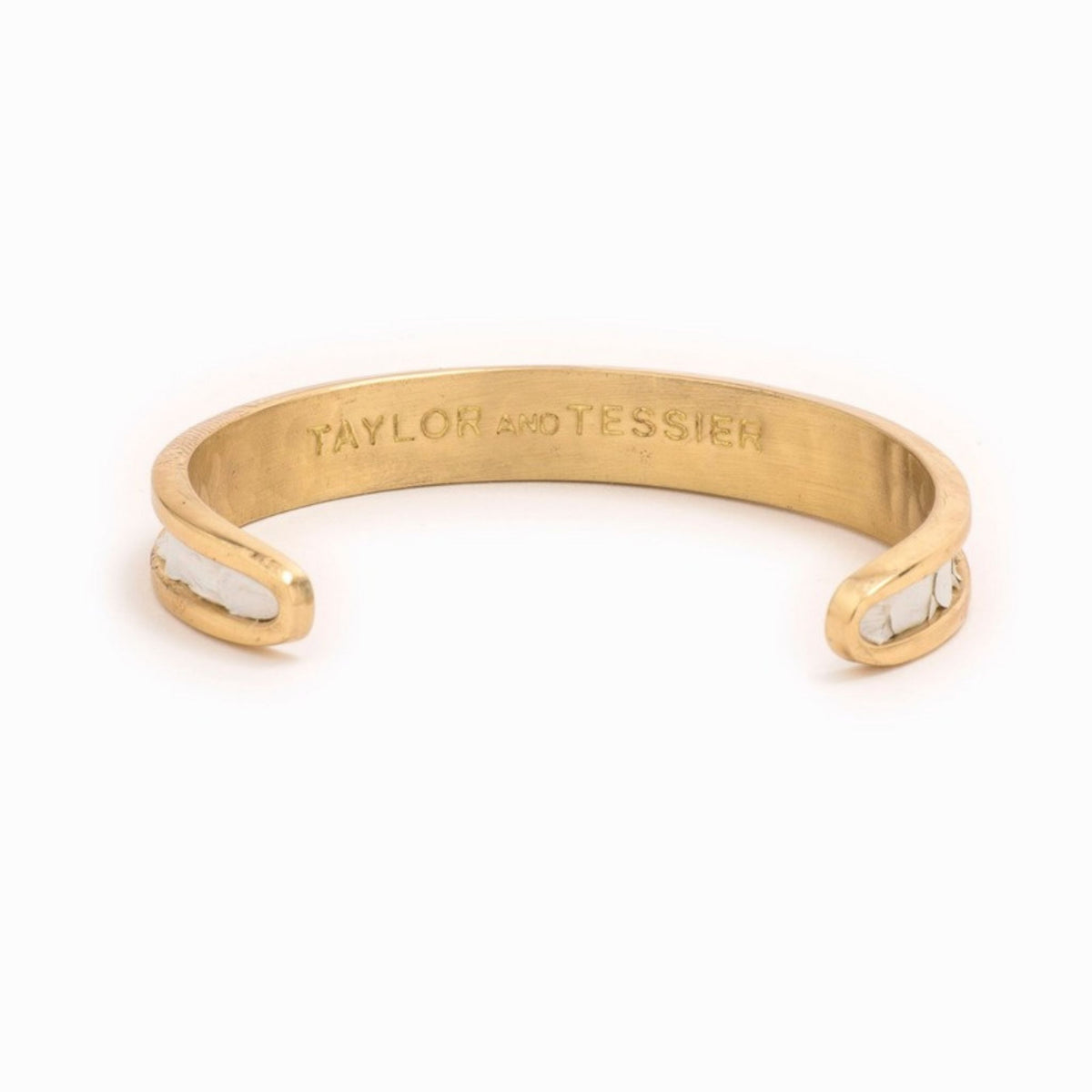Small Taylor & Tessier cuff bracelet, .5in wide, inside view, white python-embossed leather on a gold band