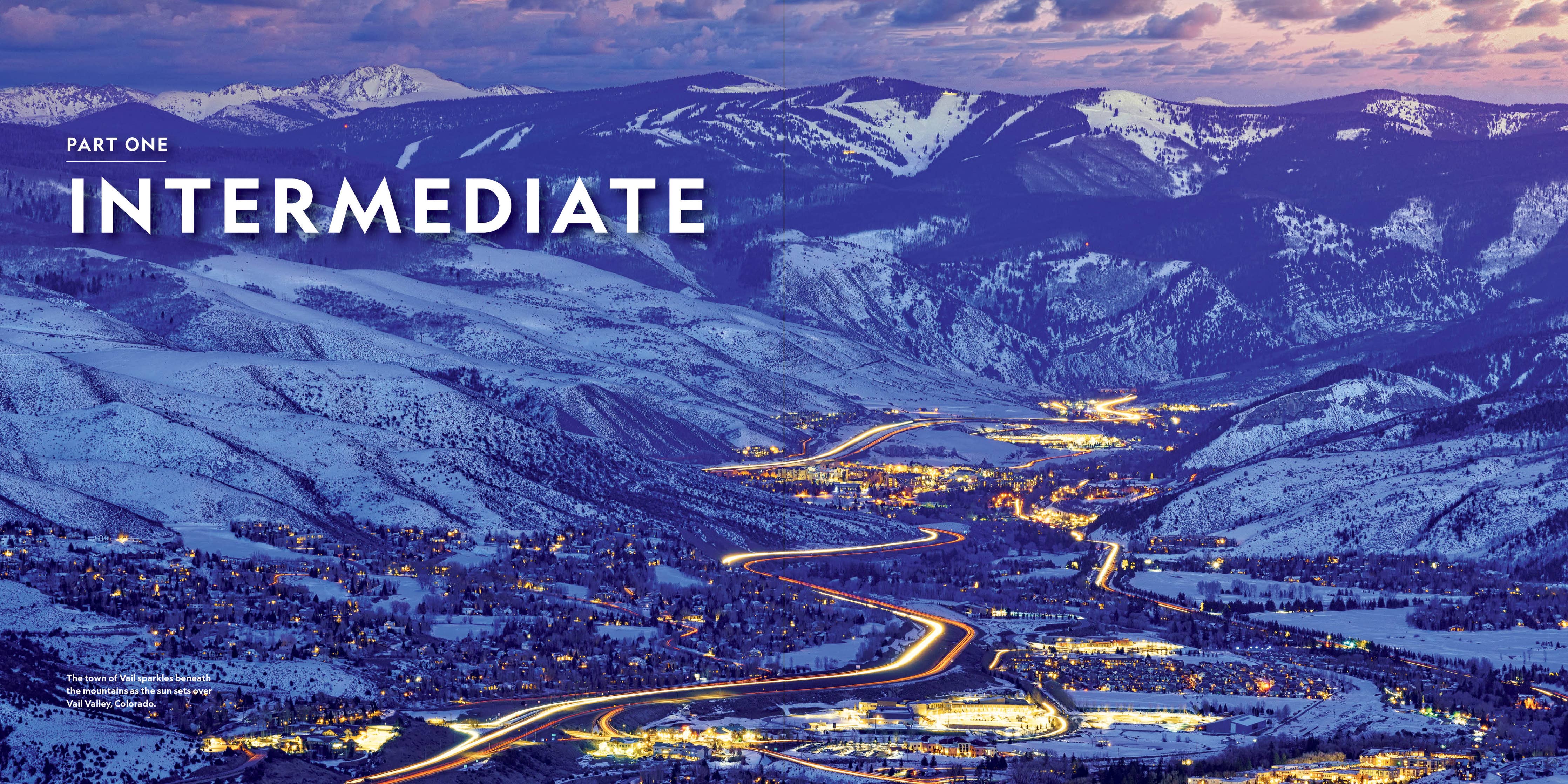 A scenic mountain landscape at dusk with snow-covered peaks, winding roads, and glowing town lights. Large overlaid text reads 'PART ONE INTERMEDIATE'.