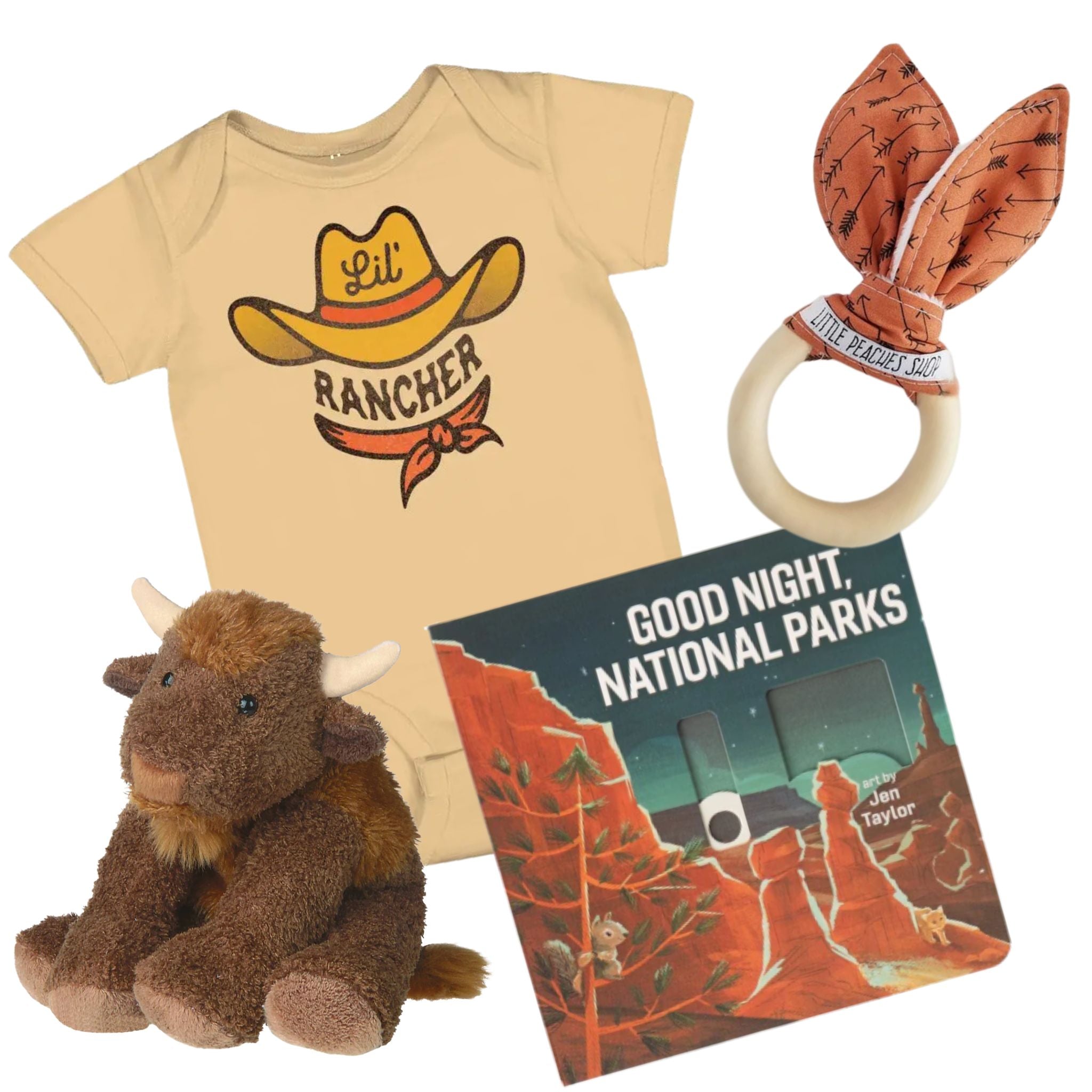 Collection of baby items including a 'Lil Rancher' t-shirt, plush toy, teething ring, and book on a white background