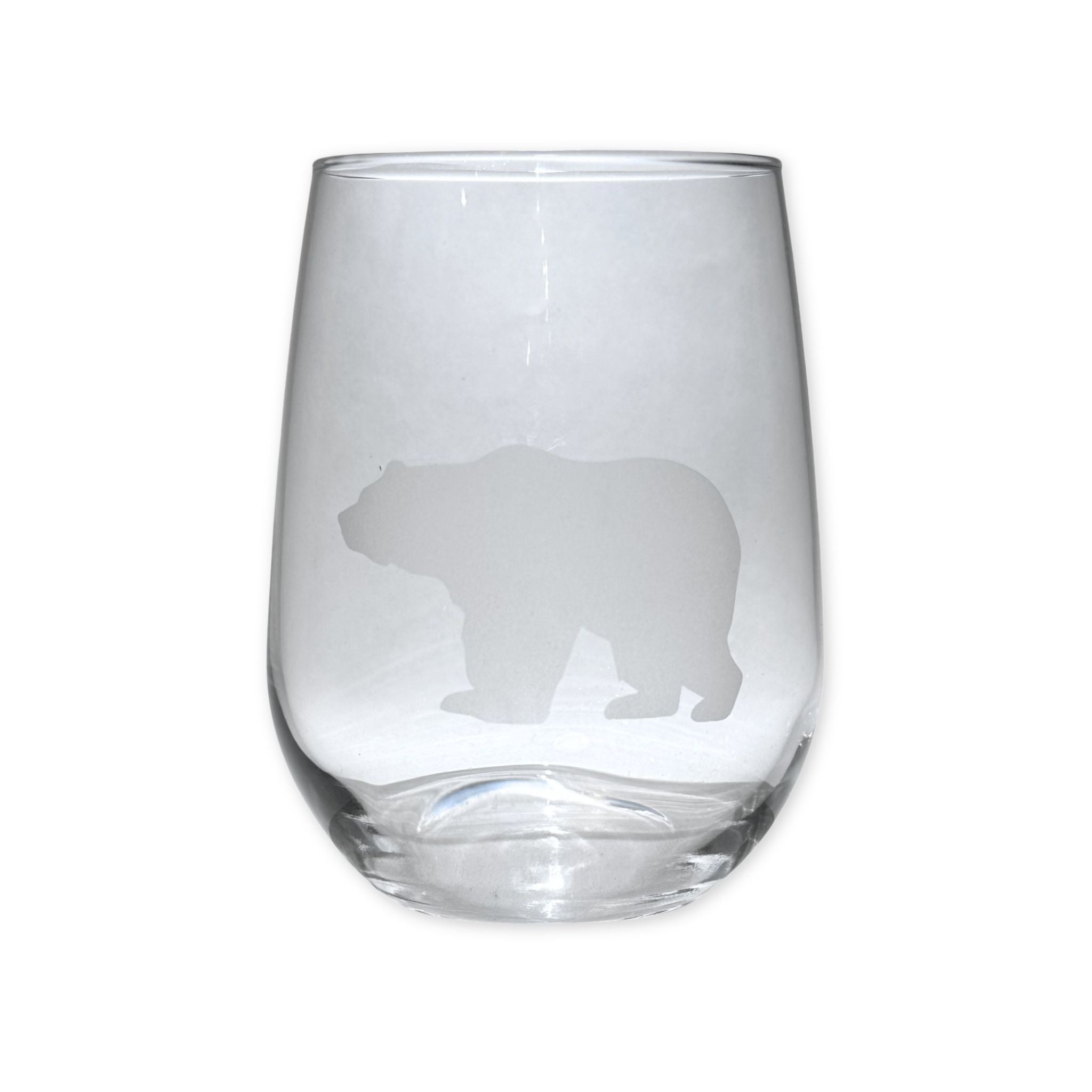 Clear glass tumbler with bear silhouette on a white background