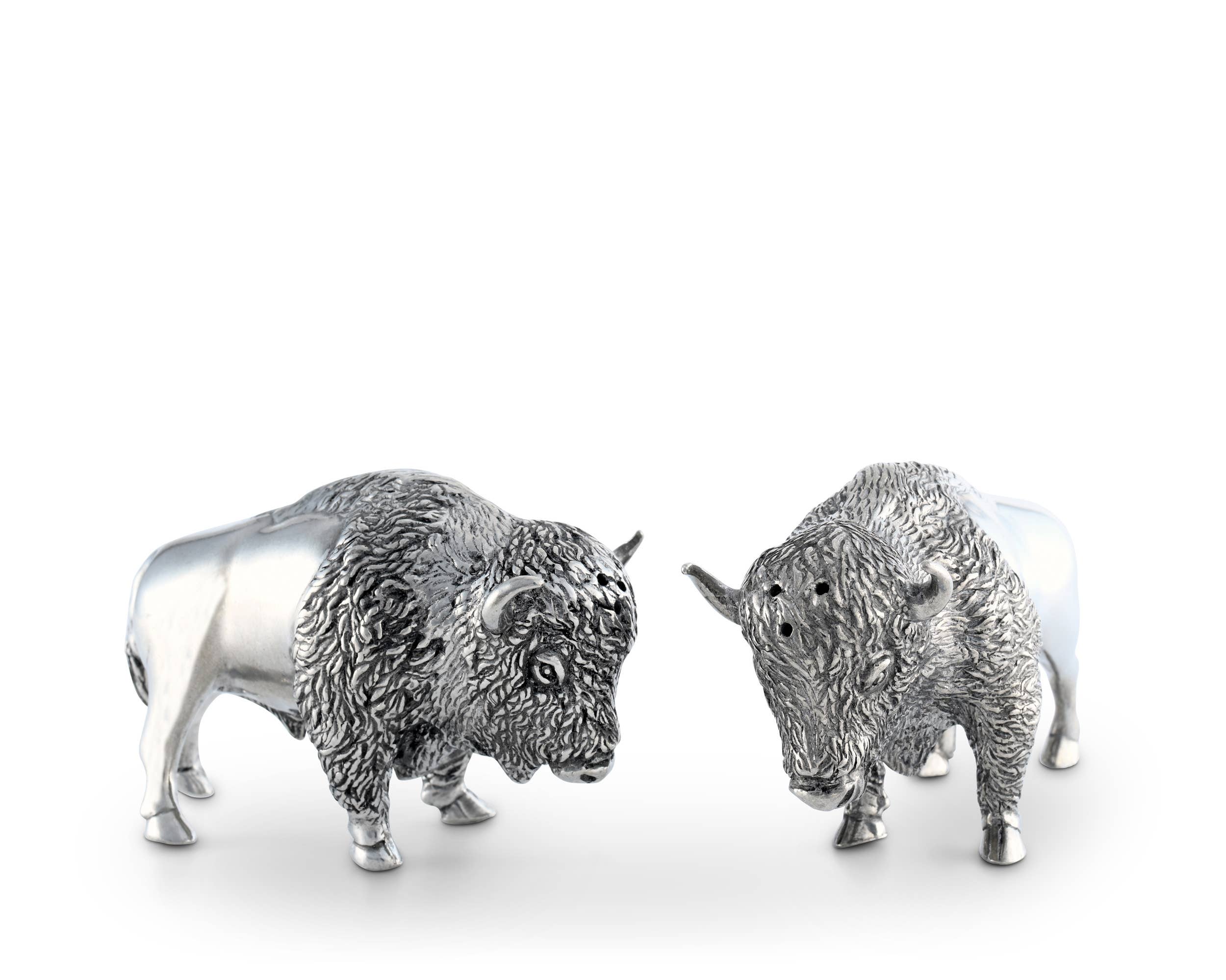 Two silver bison figurines on a white background