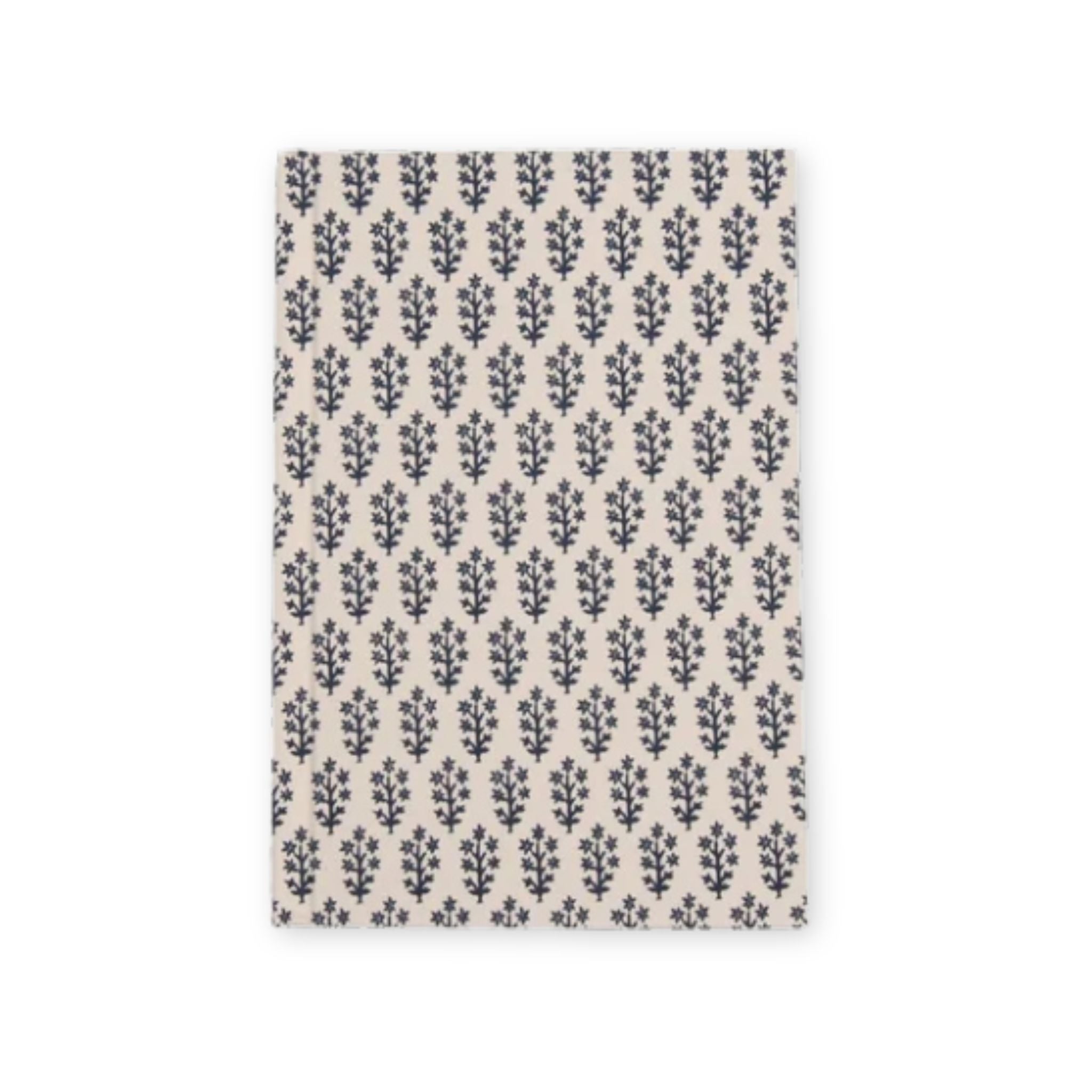 A rectangular fabric item, likely a tea towel or napkin, featuring a repeating navy blue botanical leaf pattern on a warm beige background, shown flat against a white backdrop.