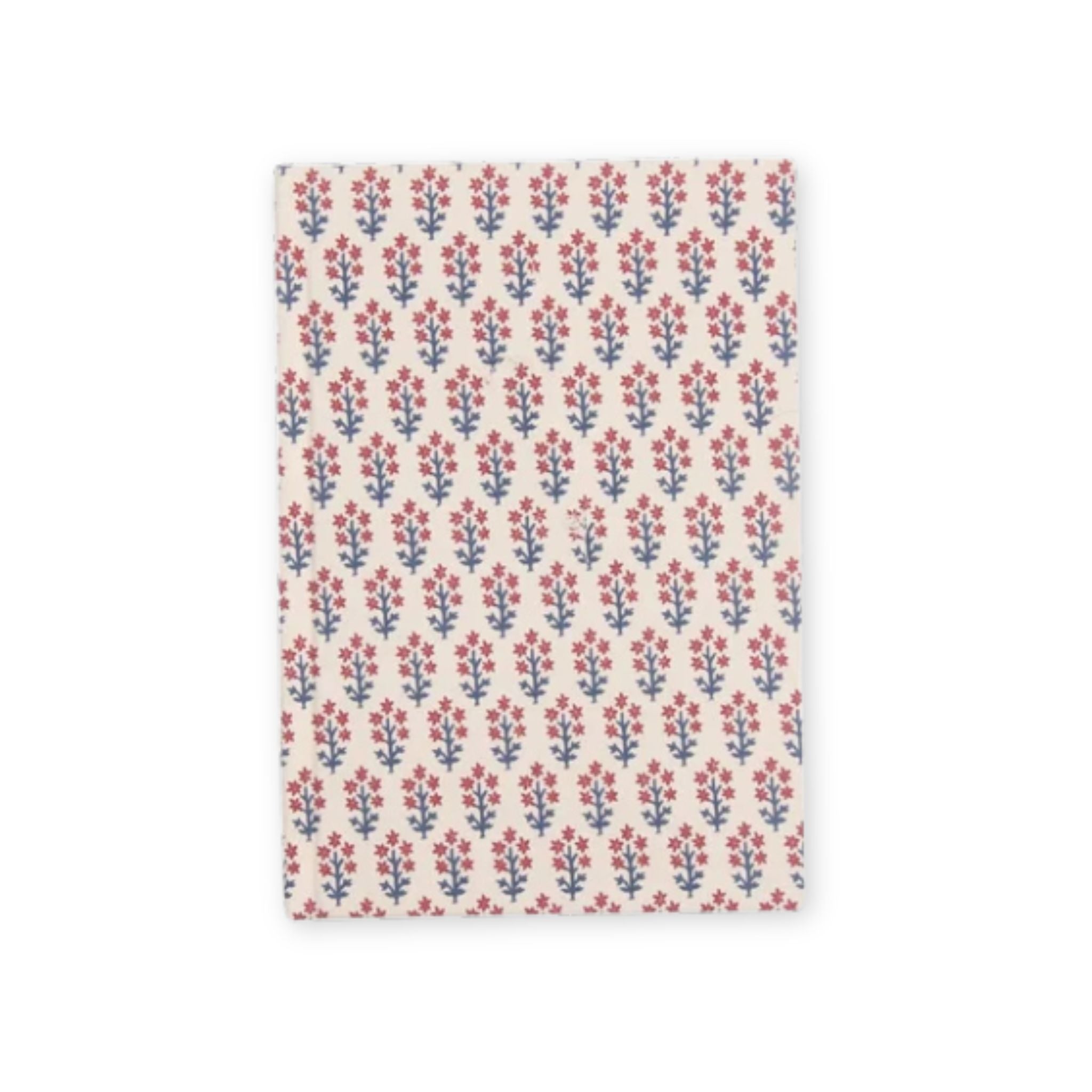 A rectangular fabric item, likely a napkin or small towel, featuring a repeating block-print floral pattern in red and blue on a warm off-white background.