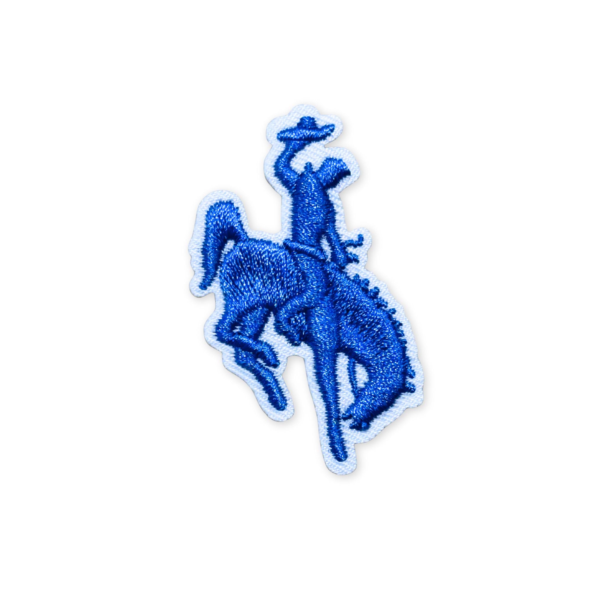 Embroidered patch, showing the silhouette of a bucking bronco and cowboy in blue stitching and white boarder. 