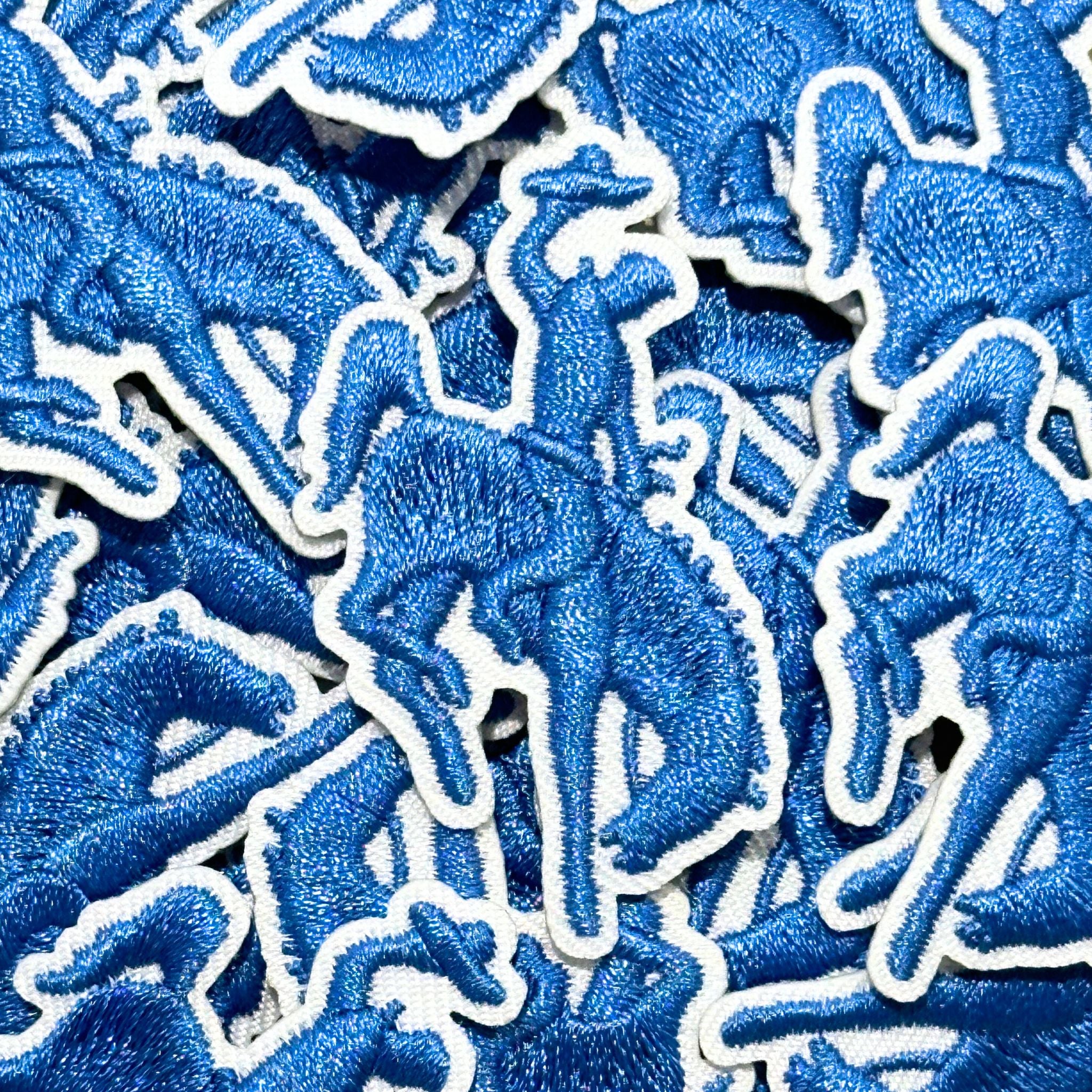 Embroidered patch, showing the silhouette of a bucking bronco and cowboy.