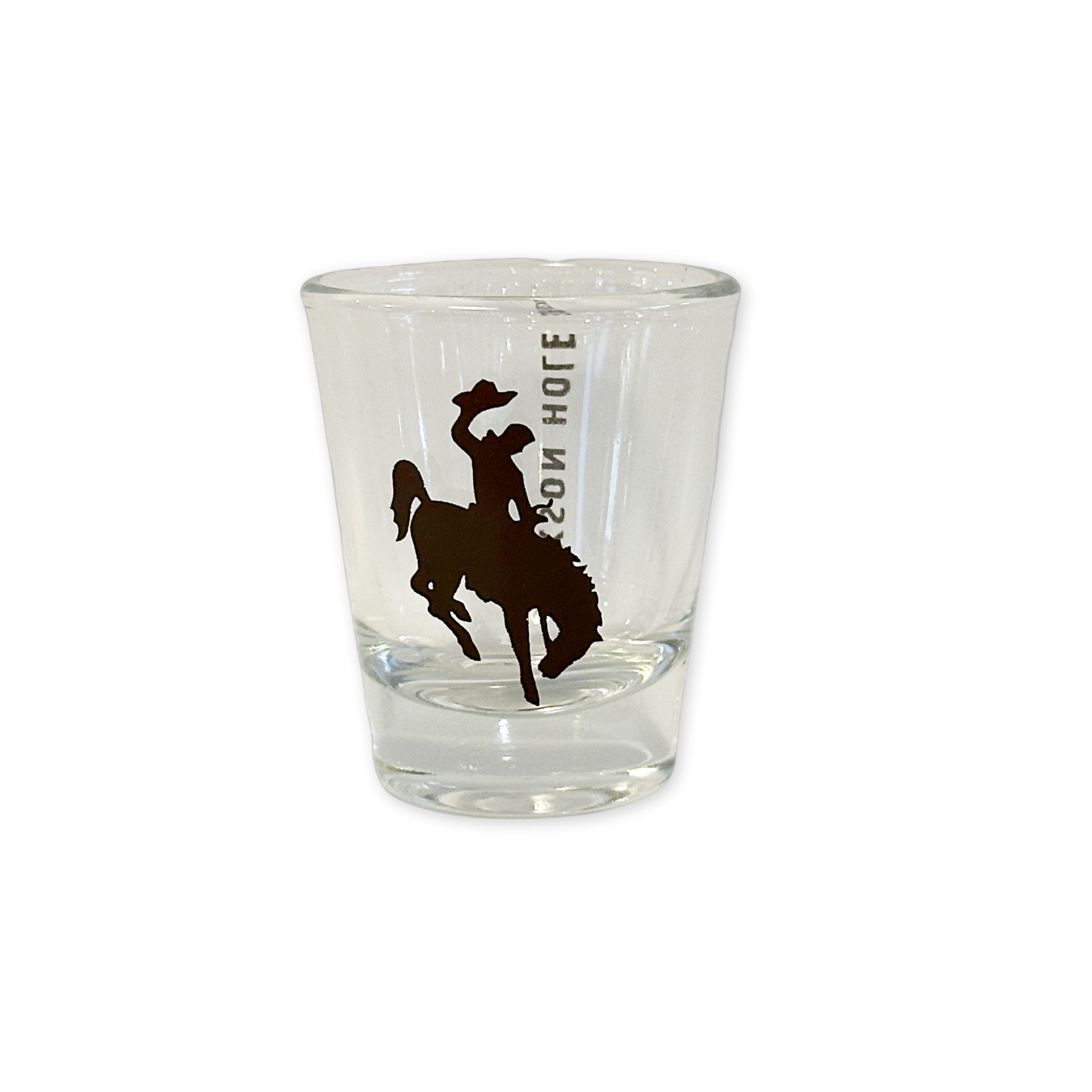 shot glass with a black wyoming bronco design and the words jackson hole printed on it