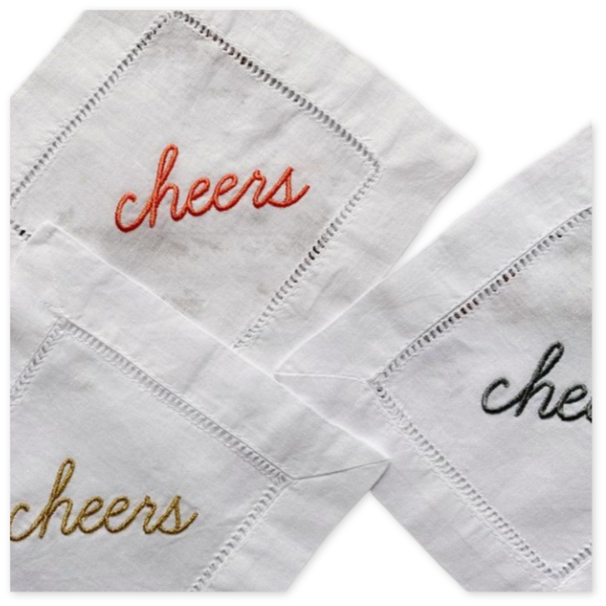 set of four cotton and linen blend cocktail napkins with the embroidered word cheers 