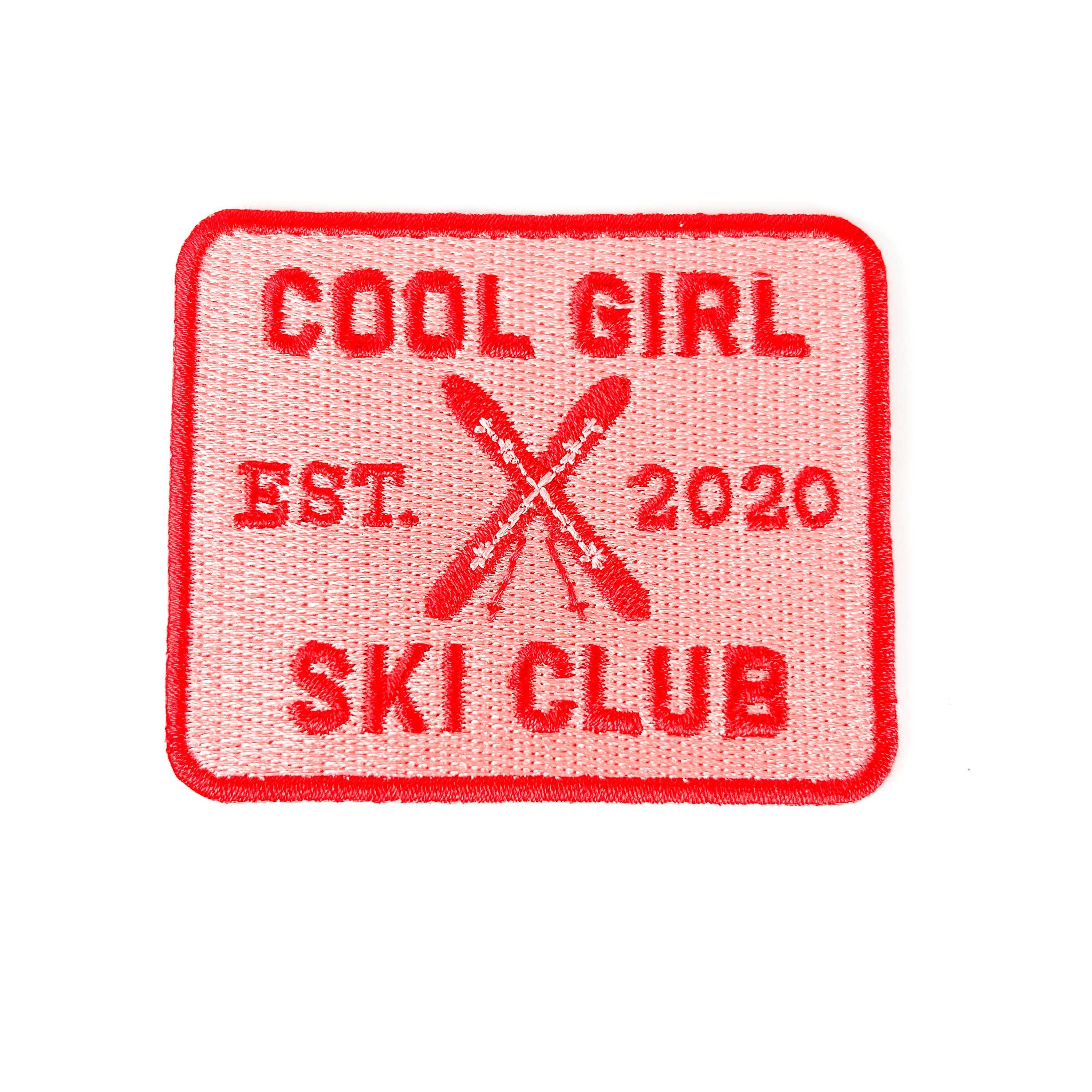 Embroidered iron on patch with 'Cool Girl Ski Club' text and ski design. 