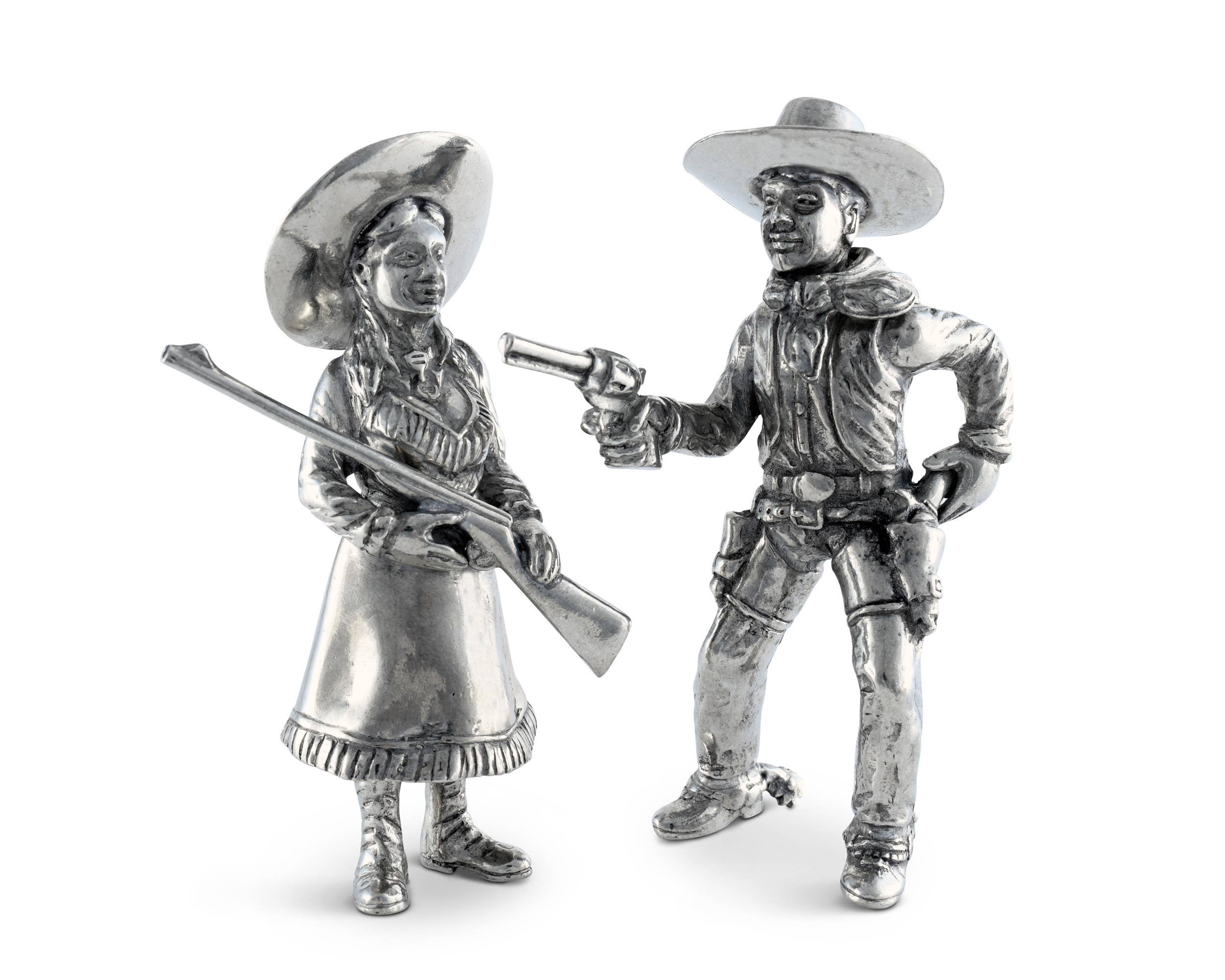 Metallic figurines of a cowboy and cowgirl on a white background salt and pepper