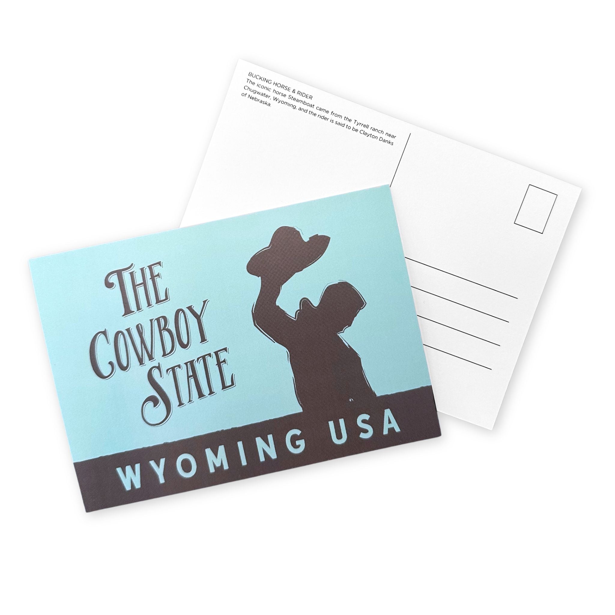 Postcard with a silhouette of a cowboy and text 'The Cowboy State Wyoming USA' on a light blue background.
