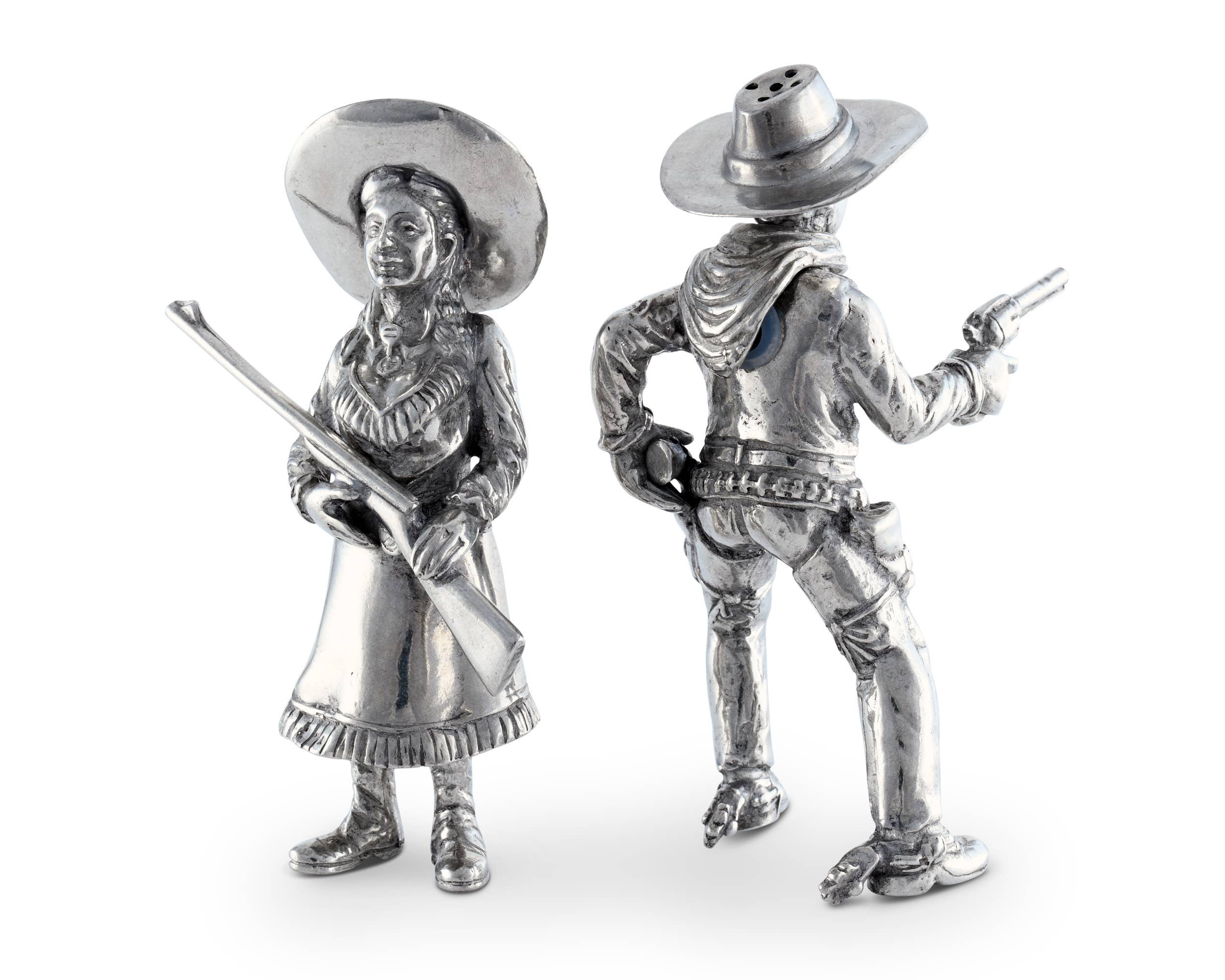 Silver cowboy and cowgirl figurines on a white background