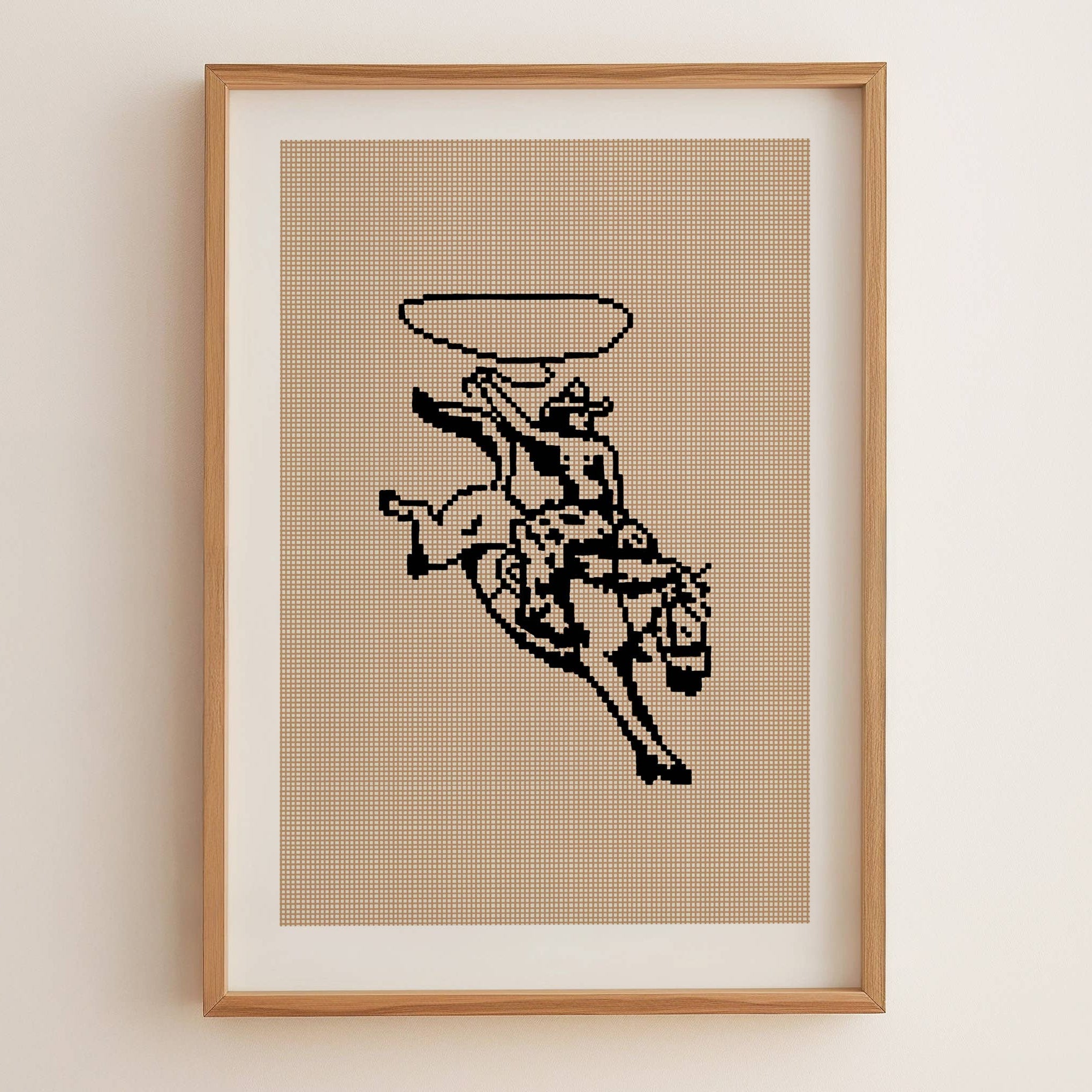 Framed cross-stitched artwork of a cowboy riding a bucking bronco on a beige background