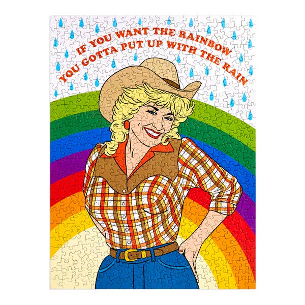 Jigsaw puzzle with a colorful design featuring a woman in a cowboy hat and rainbow, with text 'If you want the rainbow, you gotta put up with the rain'.