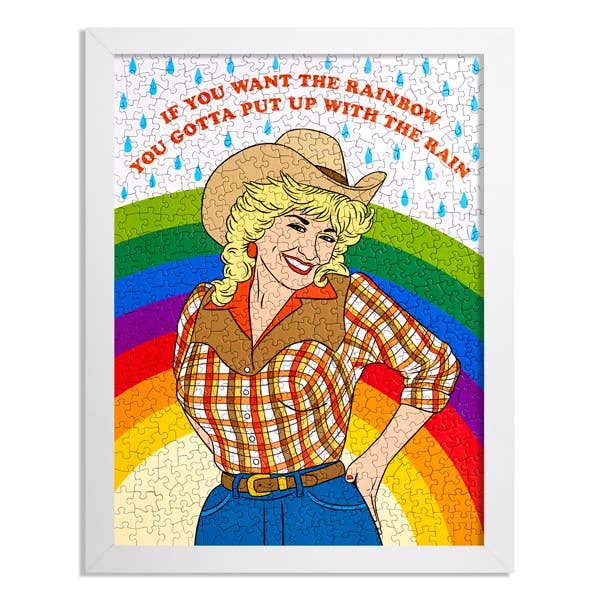 Jigsaw puzzle with a colorful design featuring a woman in a cowboy hat, rainbow, and motivational quote.